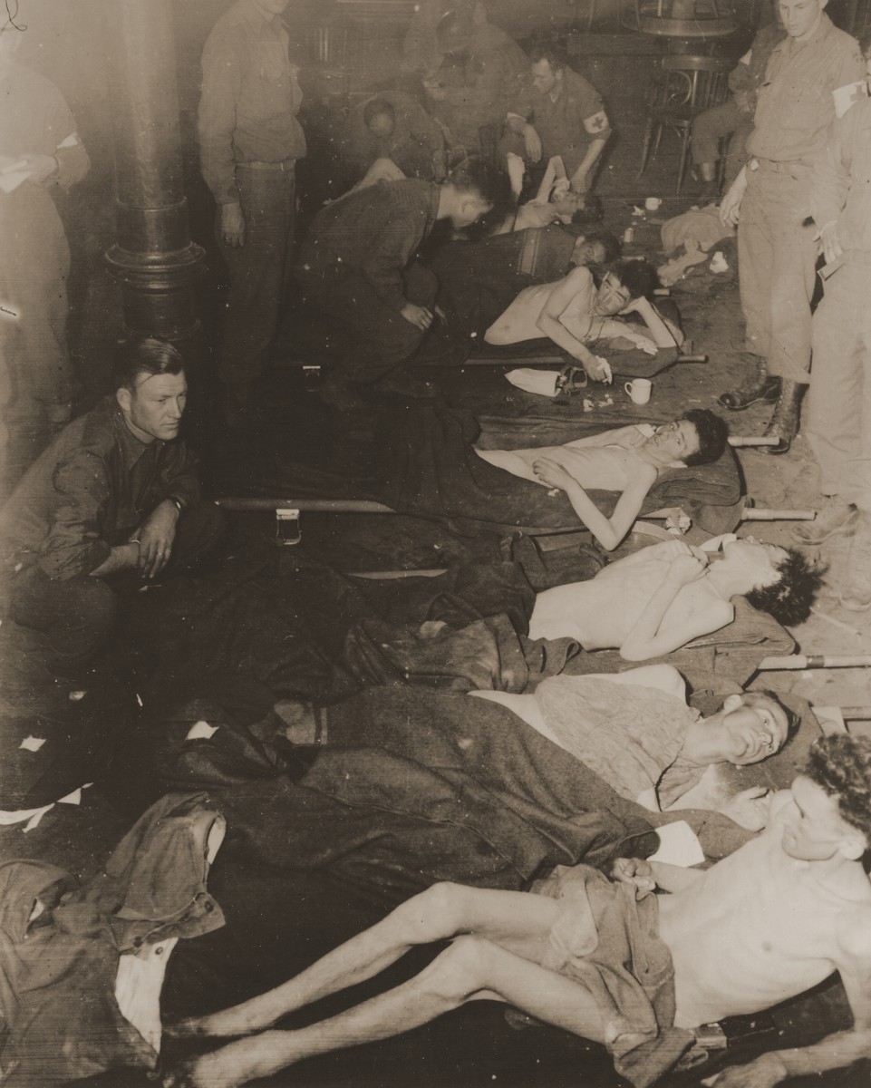 American medics treat 63 American POWs who survived a death march from the Berga concentration camp and were liberated by soldiers of the 357th Infantry Regiment.

From foreground to background: Pvt. Winfield Rosenberg, Pfc. Paul Capps, Pfc. James Watkins, Pvt. Alvin Abrams, and Pfc. Joseph Guigno. Also pictured is Pvt. Chester Sniegocki.