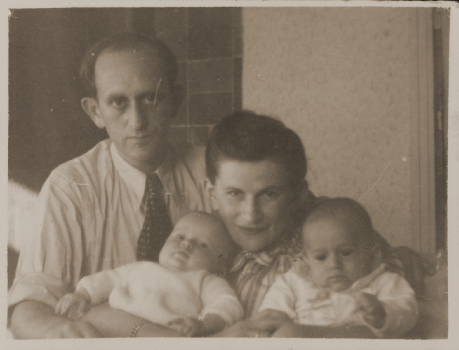 A Jewish DP couple poses with their infant twins.

Pictured are Rachmiel and Eva Zyngier with their children, Yaffa and Yizhak.  Both were from Starachowice and were survivors of the Bergen-Belsen concentration camp.