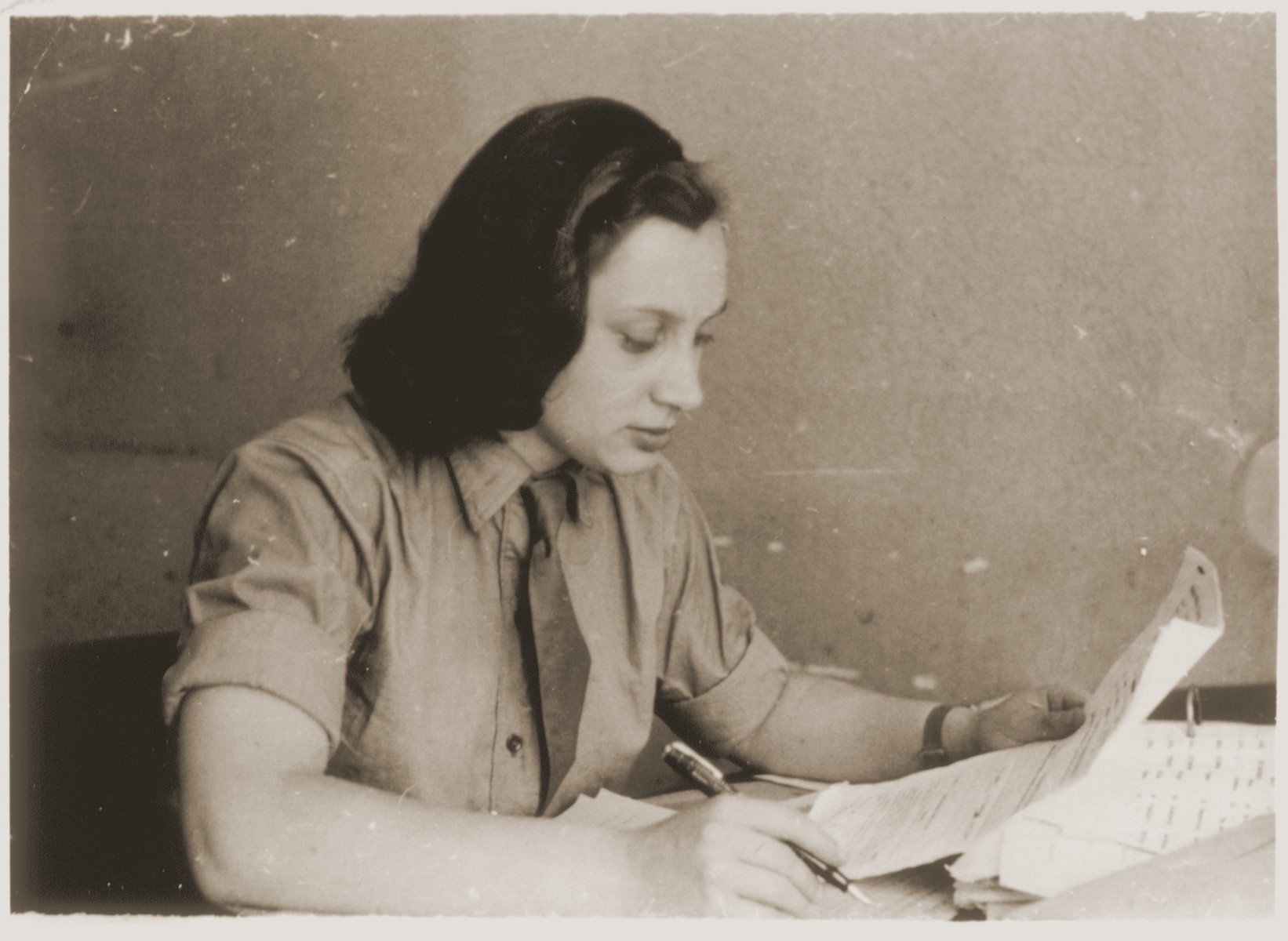 A young Jewish woman works at her desk in Munich, Germany.

Pictured is Anna Gurwitsch.