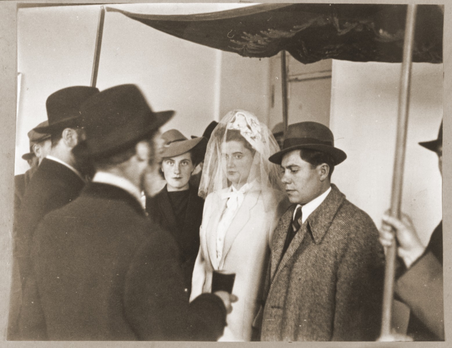 A Jewish DP couple is wed under a canopy at the Foehrenwald displaced persons camp.

The groom and bride are Sam and Regina (Gutman) Spiegel. Ester Korman is pictured in the background.