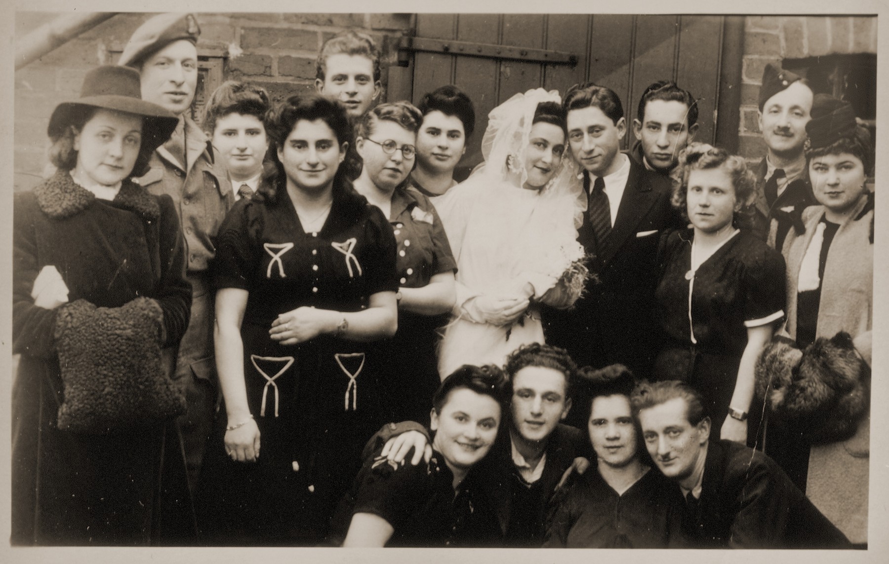 Joli Josef from Romania and Gerhard Cohn from Germany pose with their wedding guests in the Bergen-Belsen displaced persons camp.

Joli Josef is one of 17 to 20 in the Celle and Belsen DP camps who wore the gown that Lilly Friedman had made from an old German parachute her husband purchased for the purpose.