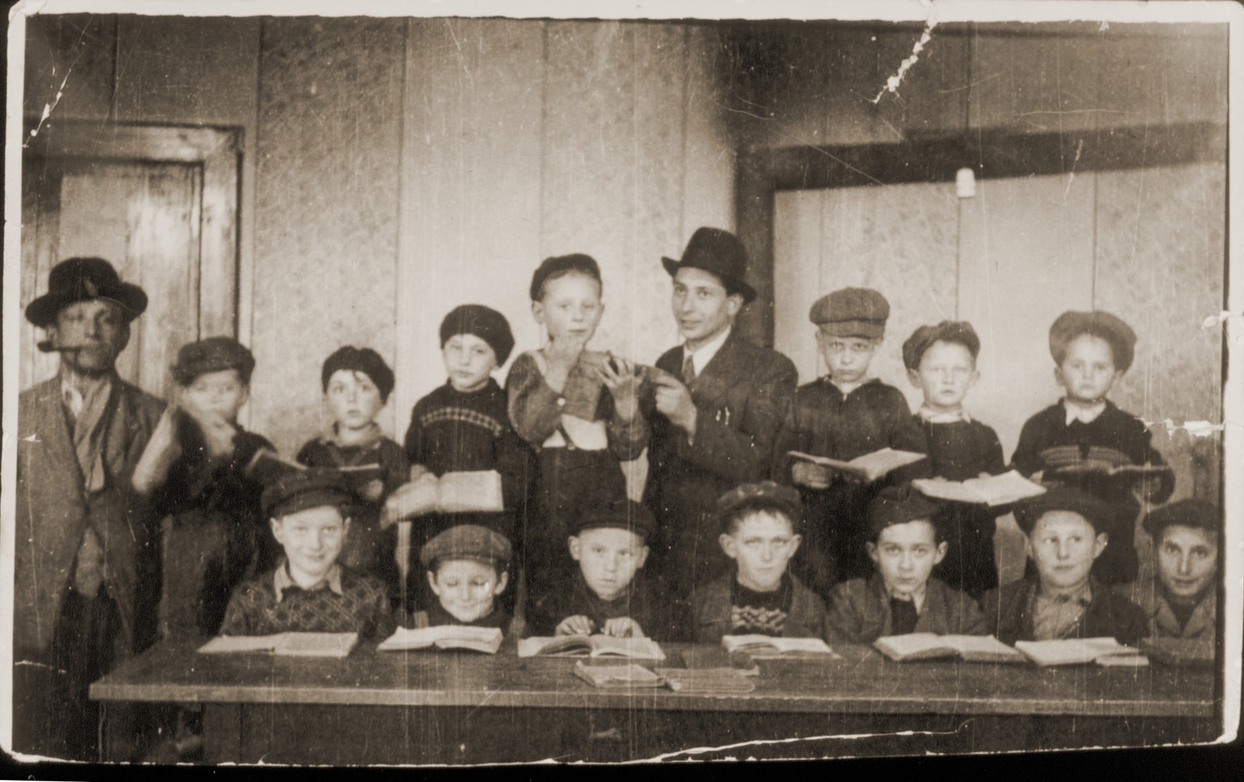 Group portrait of Jewish boys studying traditional Jewish texts at a religious school in the Feldafing displaced persons camp.

Seated from left to right are: Yaakov Stetsky, Moshe Bertram, Alter Rothbart, Moshe Lotman, Aaron Tzuckerman, Moshe Epstein and Avrohom Strikovsky.  Standing from left to right are: the synagogue director, Chaim Birnbaum, Mottel Sobolsky, Leibele Bzshisky, Wolf Strasberg, Avrohom Rosenberg, the teacher, Meir Katz, Shimon Lipinsky, and Chaim Frashkir.