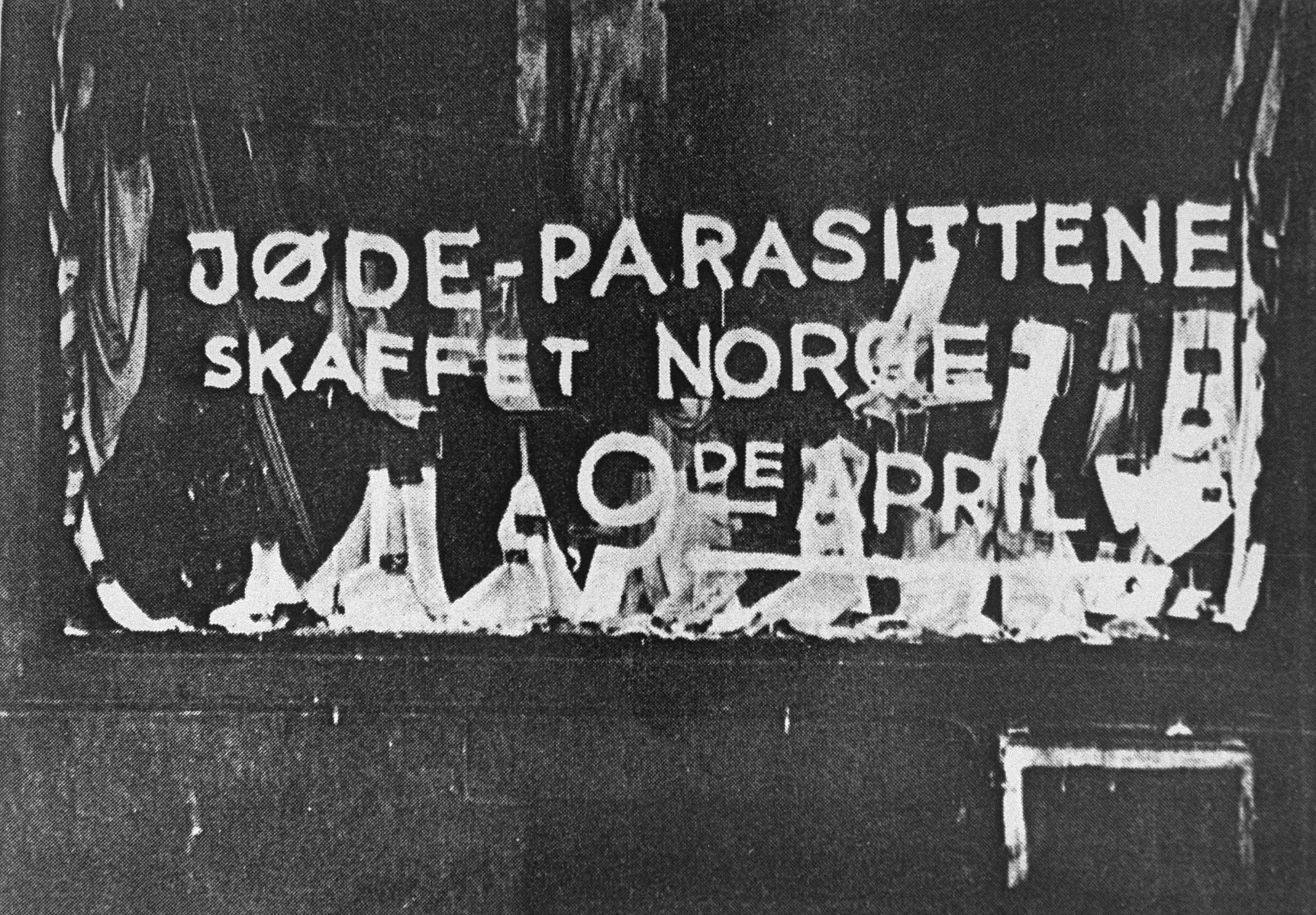 Anti-semitic graffiti painted on the window of a Jewish business reads: "The Jewish parasite sold Norway on the 9th of April [the date of the German invasion in 1940]."