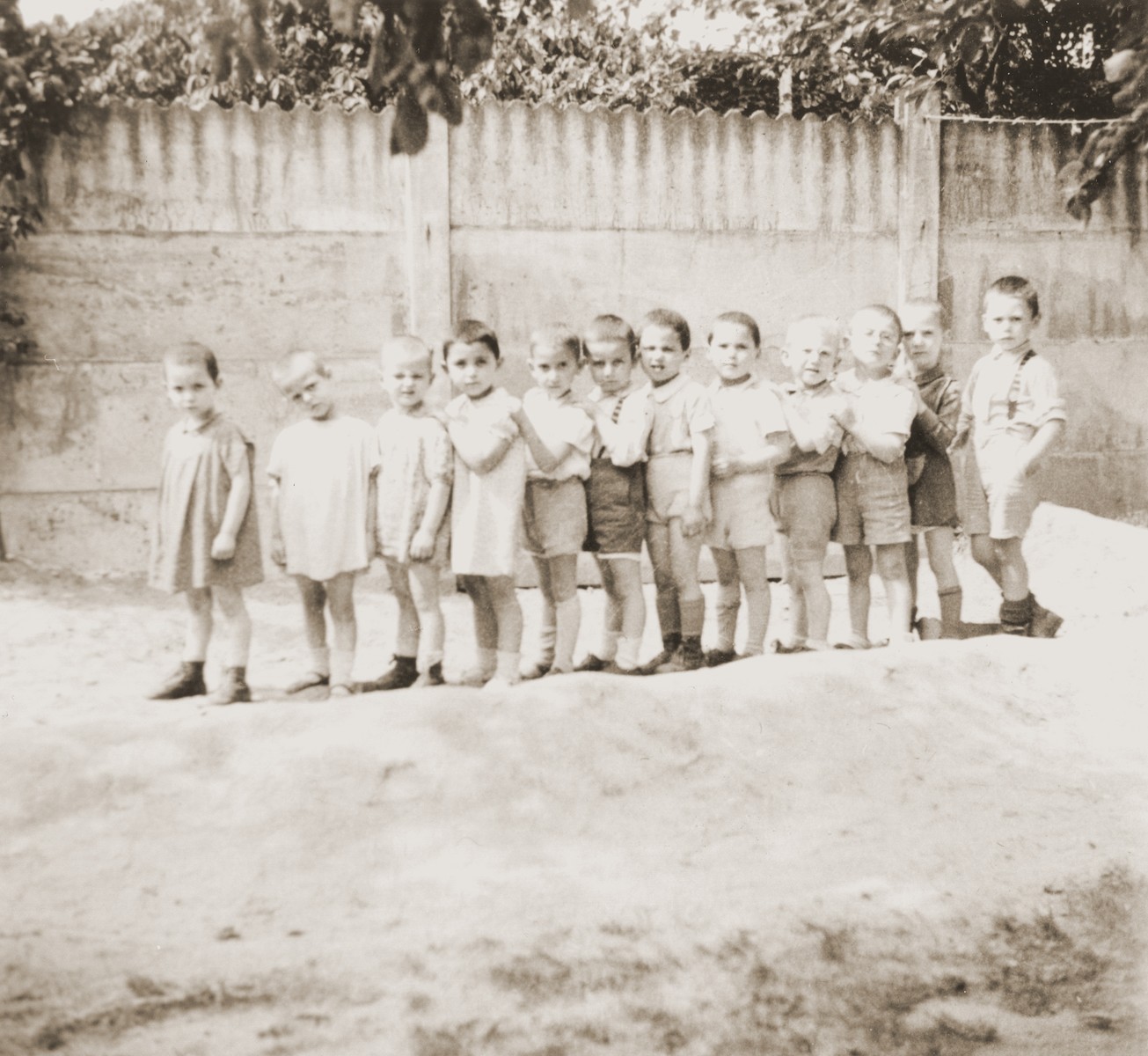 A group of toddlers form a line in the yard of the La Pouponniere children's home in Belgium.