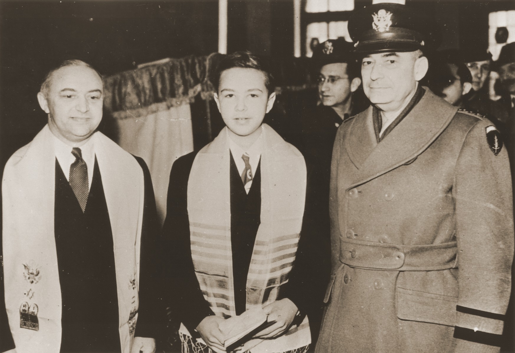 Stephen Bernstein poses with his father, Philip Bernstein (left), adviser on Jewish affairs to the U.S. Army commander in Europe, and General Joseph McNarney, during his bar mitzvah at the Philanthropin School in Frankfurt.
