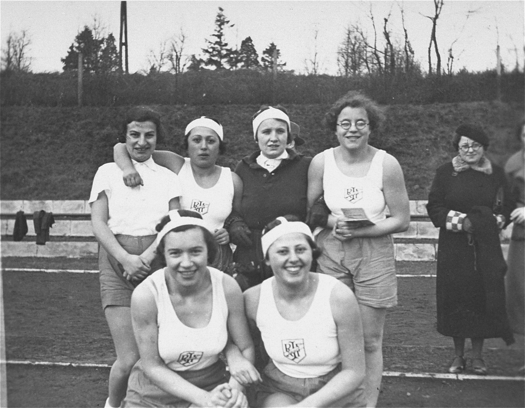 Group portrait of members of the women's handball team sponsored by the Reichsbund juedischer Frontsoldaten.  

The donor, Ilse Dahl, is pictured in the front row, on the left. In the front row on the right is Edith Hermann.  Pictured (left to right) in the back row are [unidentified], Edith's sister  Else Hermann (probably), [unidentified], and Hedwig ("Hete")  Saul from Aachen.  Standing behind the group on the right, wearing a coat, is Josephine Lüth.