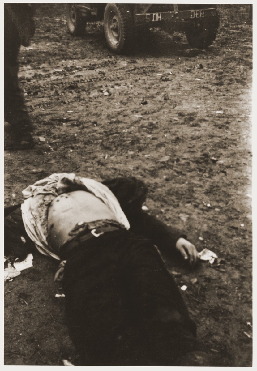 The corpse of a German guard with a swastika on his chest, who was killed by inmates during the liberation of Ohrdruf.  

The photographer was an American soldier serving in the 69th Infantry Division, which participated in the liberation of Ohrdruf.