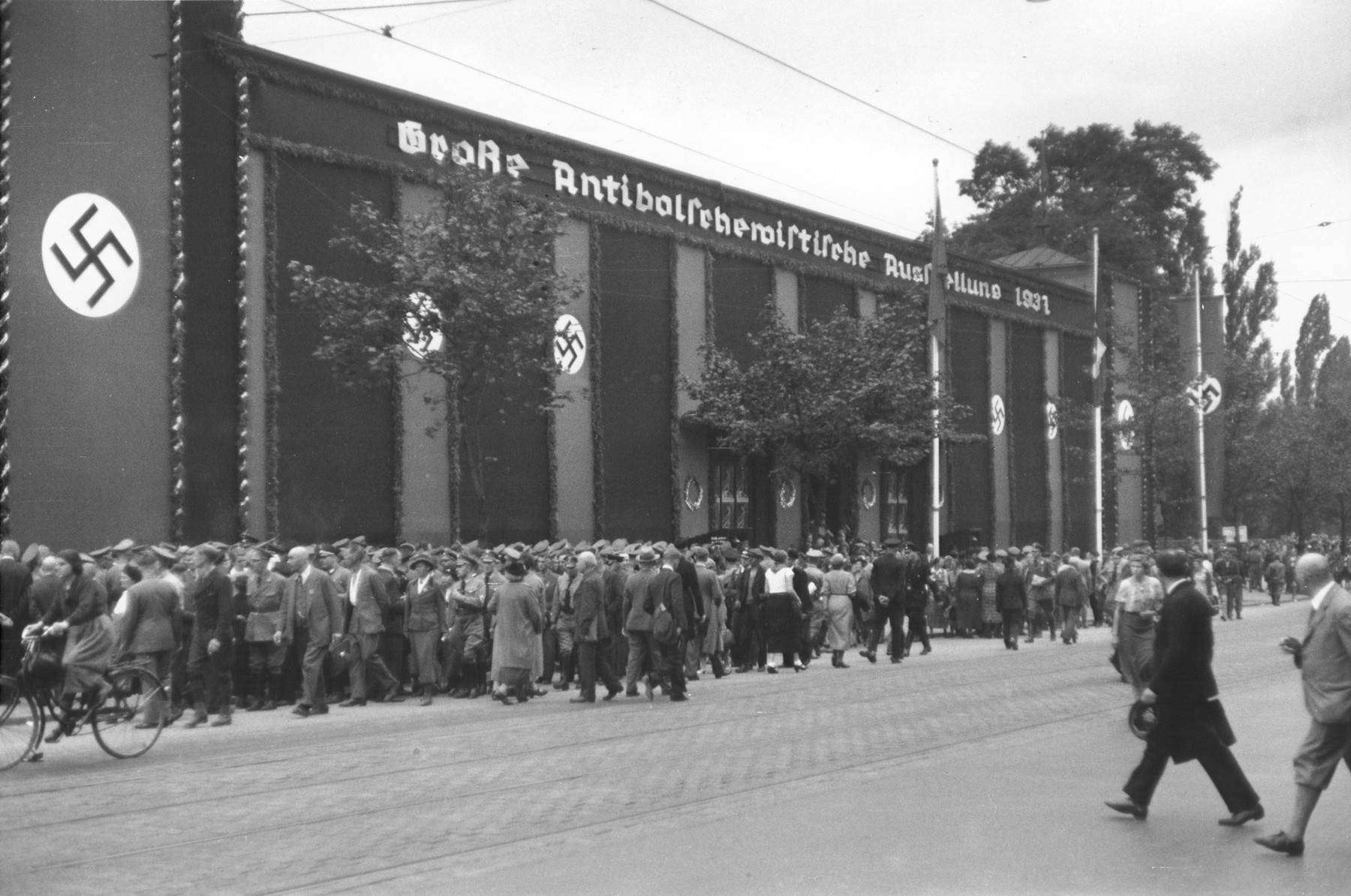 Visitors line up in front of a hall adorned with Nazi banners in order to attend the opening of the Great Anti-Bolshevism Exhibition 1937 (Grosse Antibolschewistische Ausstellung) in Nuremberg.