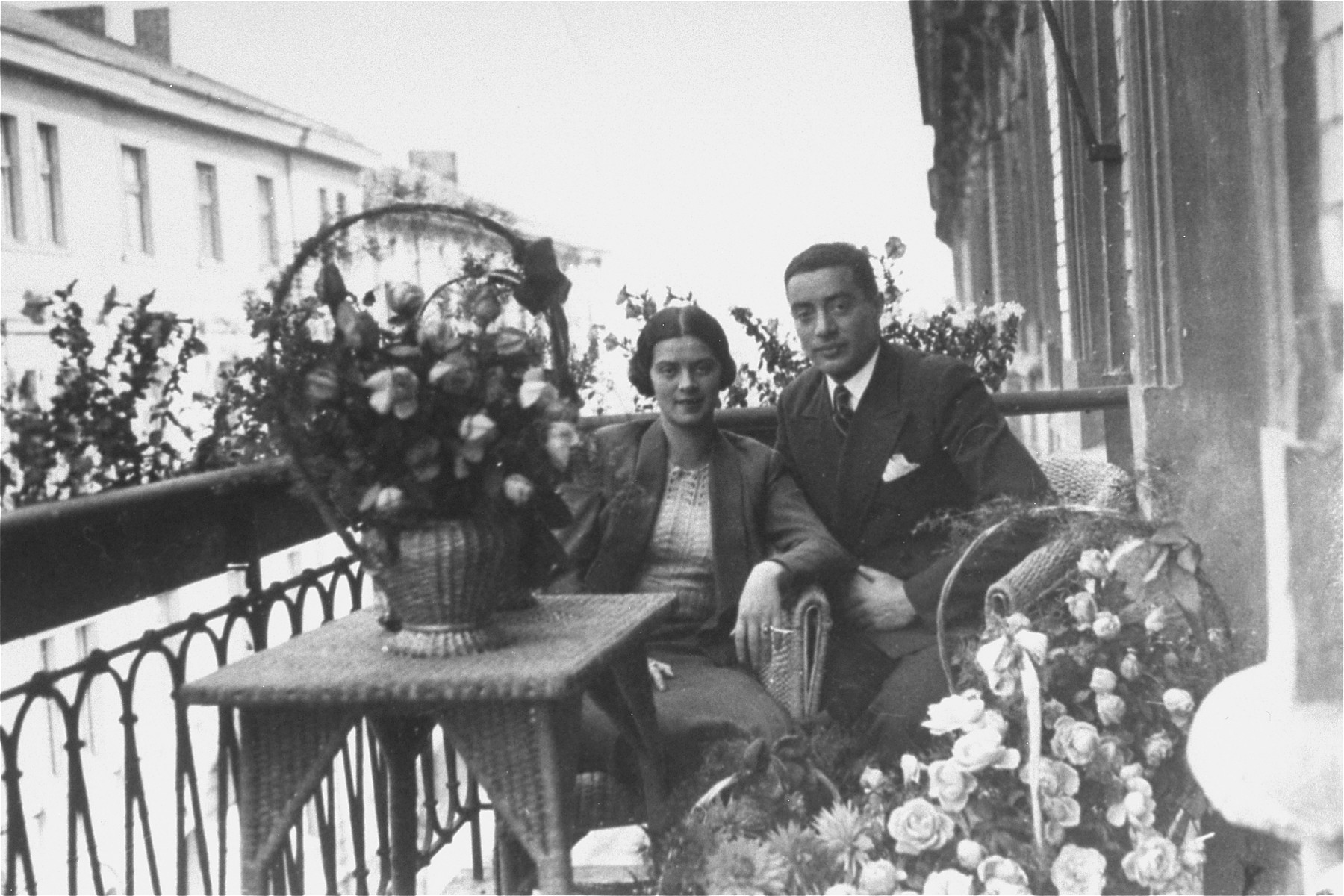 Portrait of a Jewish couple on a balcony in Rzeszow, Poland during their engagement party. 

Pictured are Mina Nattel and Beno Schmelkis. During the war Mina, Beno and their daughter Rachel were killed by the Germans.