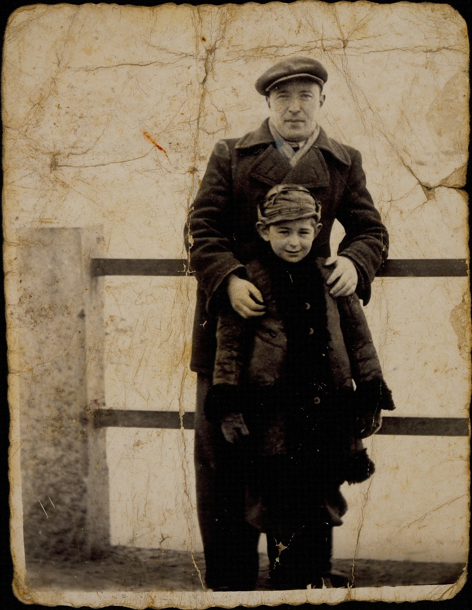 The photographer, Ben-Zion Szrejder, who managed the photography studio of Alte Katz, poses with her oldest grandson, Yitzhak Sonenson, on the shtetl bridge.