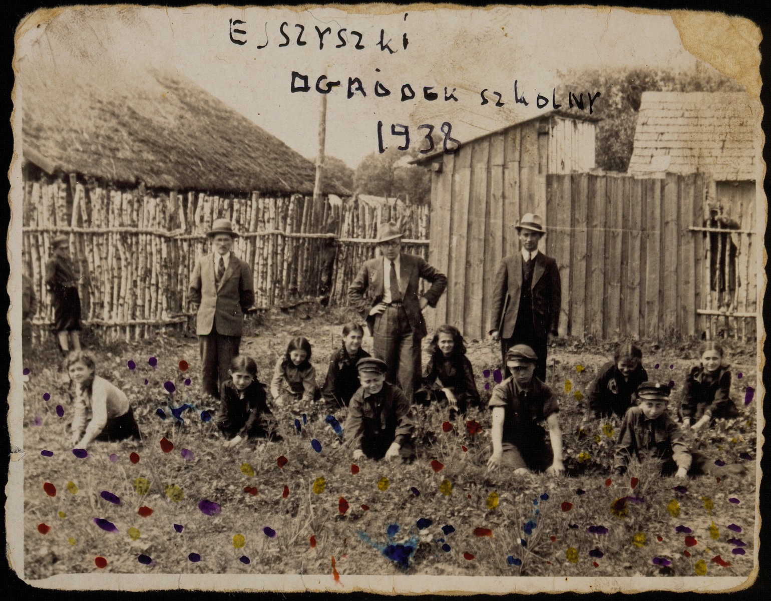 Children from the Hebrew School work in the school's garden in preparation for immigration to Palestine. 

Supervising them are three of their teachers: (right to left) a teacher from the shtetl of Belski, Mr. Okun, and Shaul Schneider (front row, right to left) Avigdor Katz, Moshe Kaplan, Elisha Koppelman, Sheinele Dwilanski; (back row, right to left) Hayya Shlanski, Rachel Koppelman, Leah Michalowski, (first name unknown) Zila, and a girl from the Narodowicz family.  

Hayya immigrated to America; Leah Michalowski was one of the girls raped by "White Jacket," the Gestapo commander of Eisiskes; Rachel was killed by the Polish Home Army; the others were murdered by the Germans during the September 1941 mass shooting action in Eisiskes.