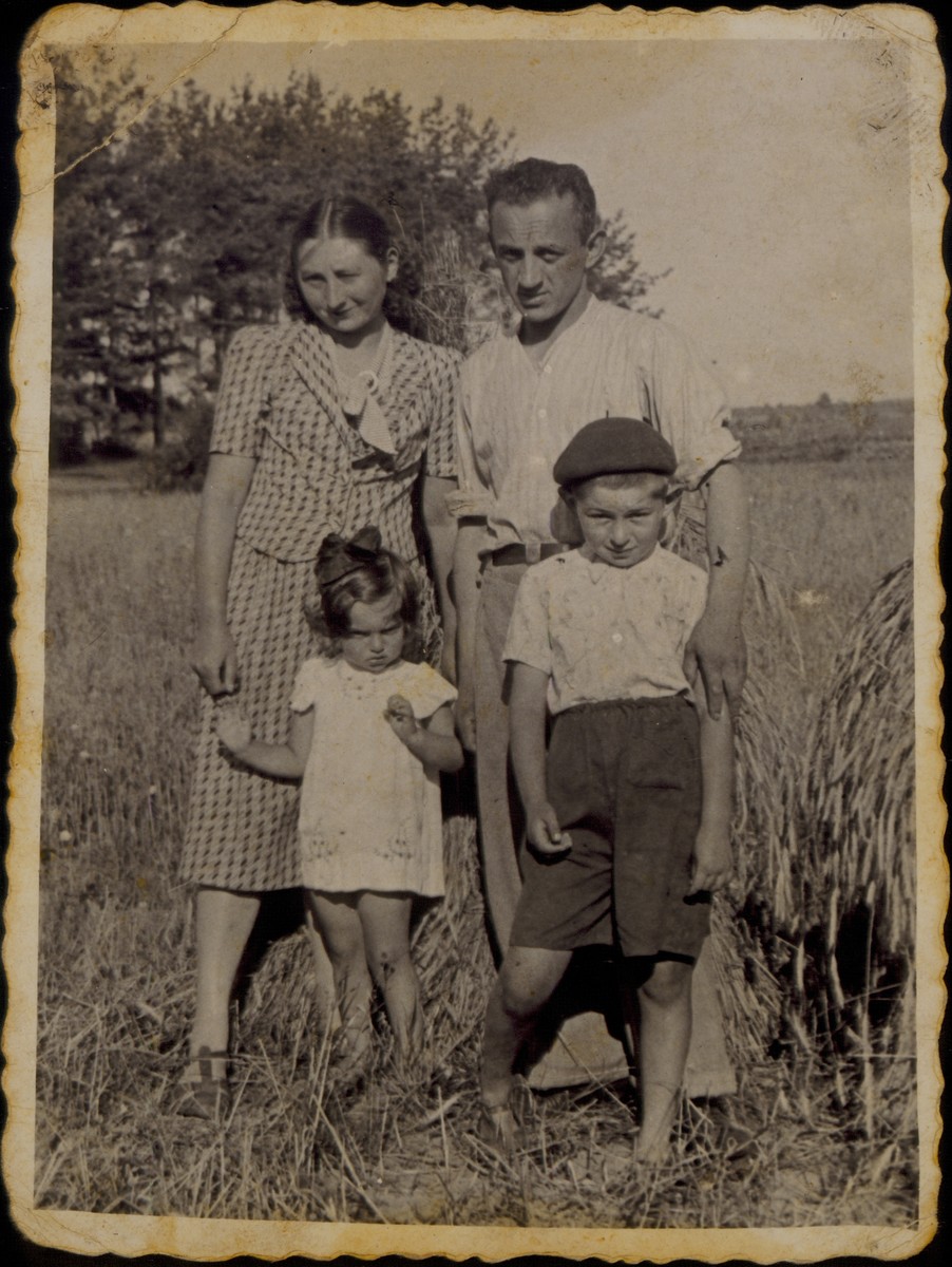 Moshe Sonenson poses with his wife and children in a field they once owned.

Pictured are Moshe and Zipporah Sonenson and their children Yaffa and Yitzhak Uri.