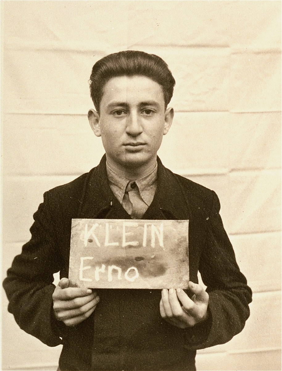 Erno Klein holds a name card intended to help any of his surviving family members locate him at the Kloster Indersdorf DP camp.  This photograph was published in newspapers to facilitate reuniting the family.