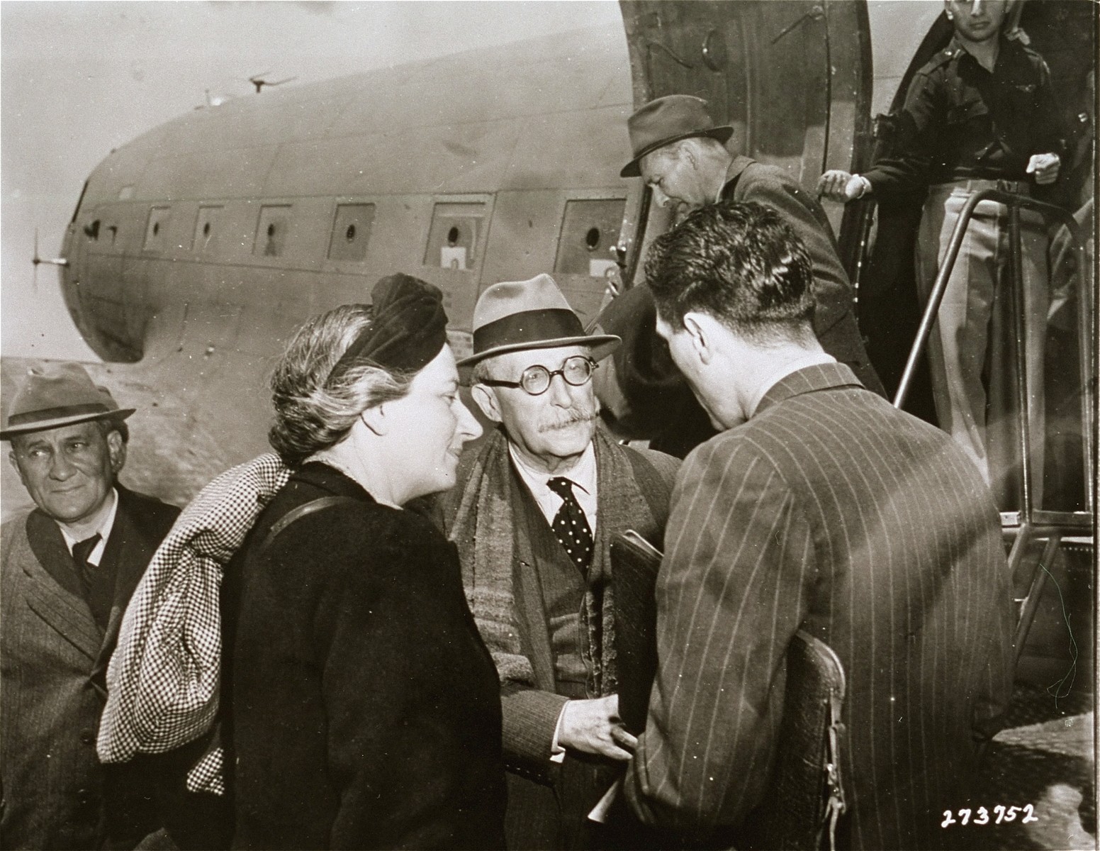 Former French Premier Leon Blum and his wife are greeted by T.S. Estes upon their arrival in Naples aboard an American plane.