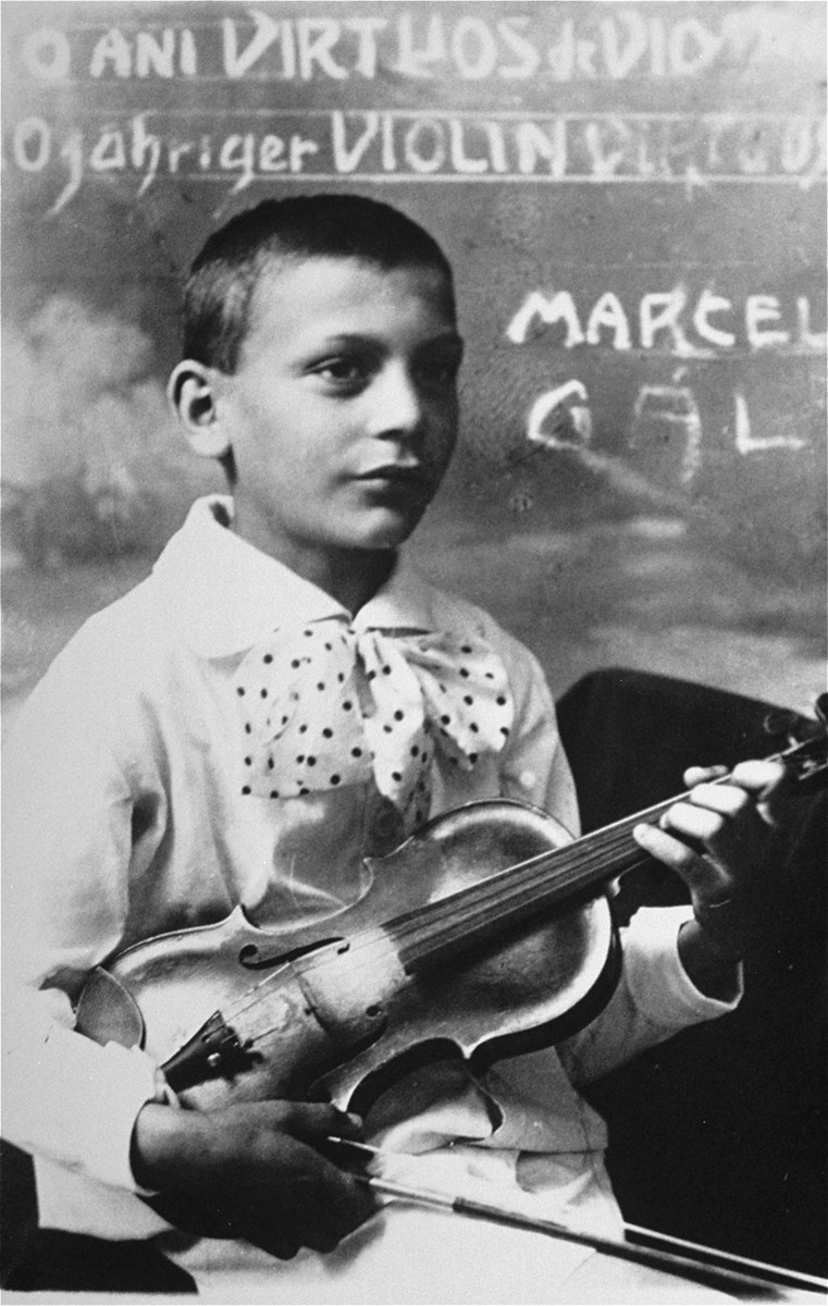 Portrait of Marcell (nicknamed "Bandi")  Gal (born Gottlieb), a child violin prodigy from Sighet.  His brother, Janos, was also a violinist.  

One photograph among a series of family portraits taken by a Jewish studio photographer in Sighet, Romania in the 1920's and 30's.