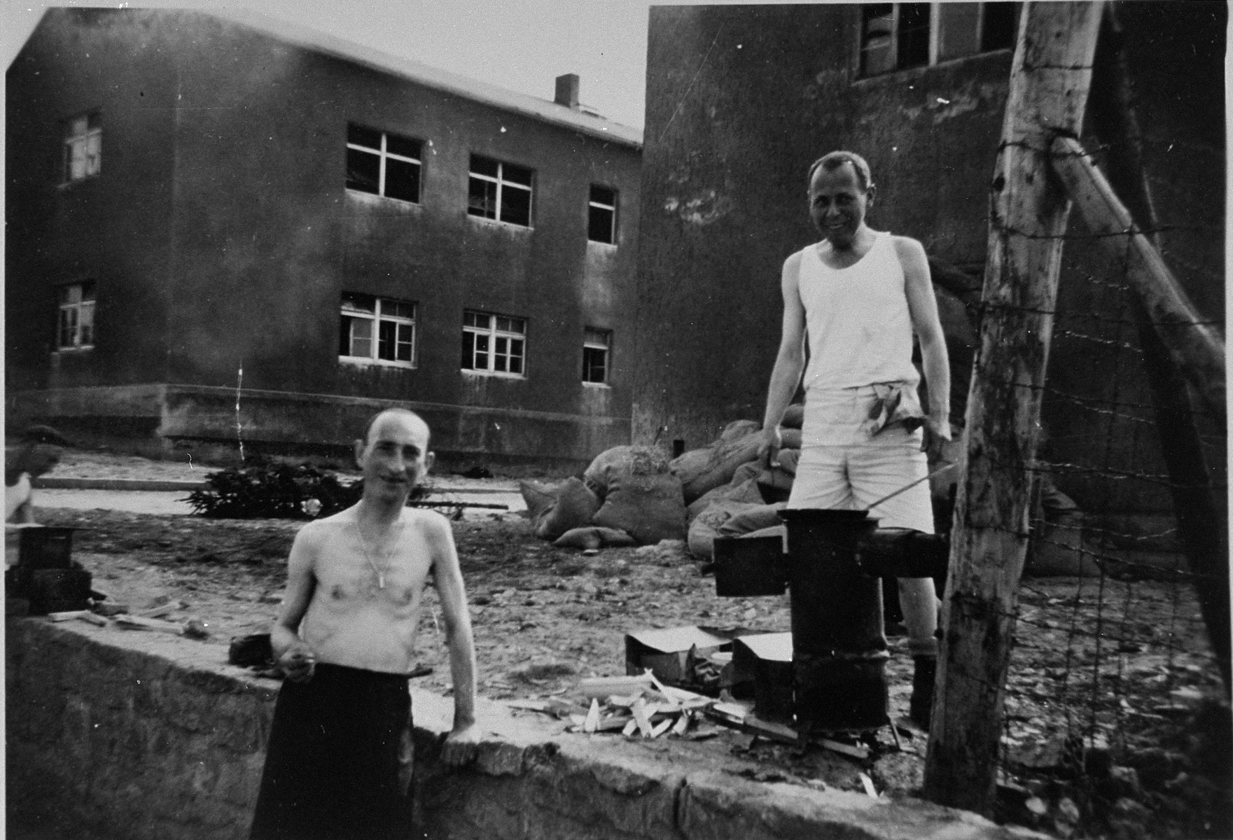 Two Buchnewald survivors in Buchenwald prepare a meal after liberation.  

The inscription on the back of the photograph reads, "Buchenwald Prison Camp Inmates.  5/7/45.  Man on left from Antwerp weighed 90 kilos (180 lbs) on entry to camp.  When picture was taken weighed 40 kilos (80 lbs.).