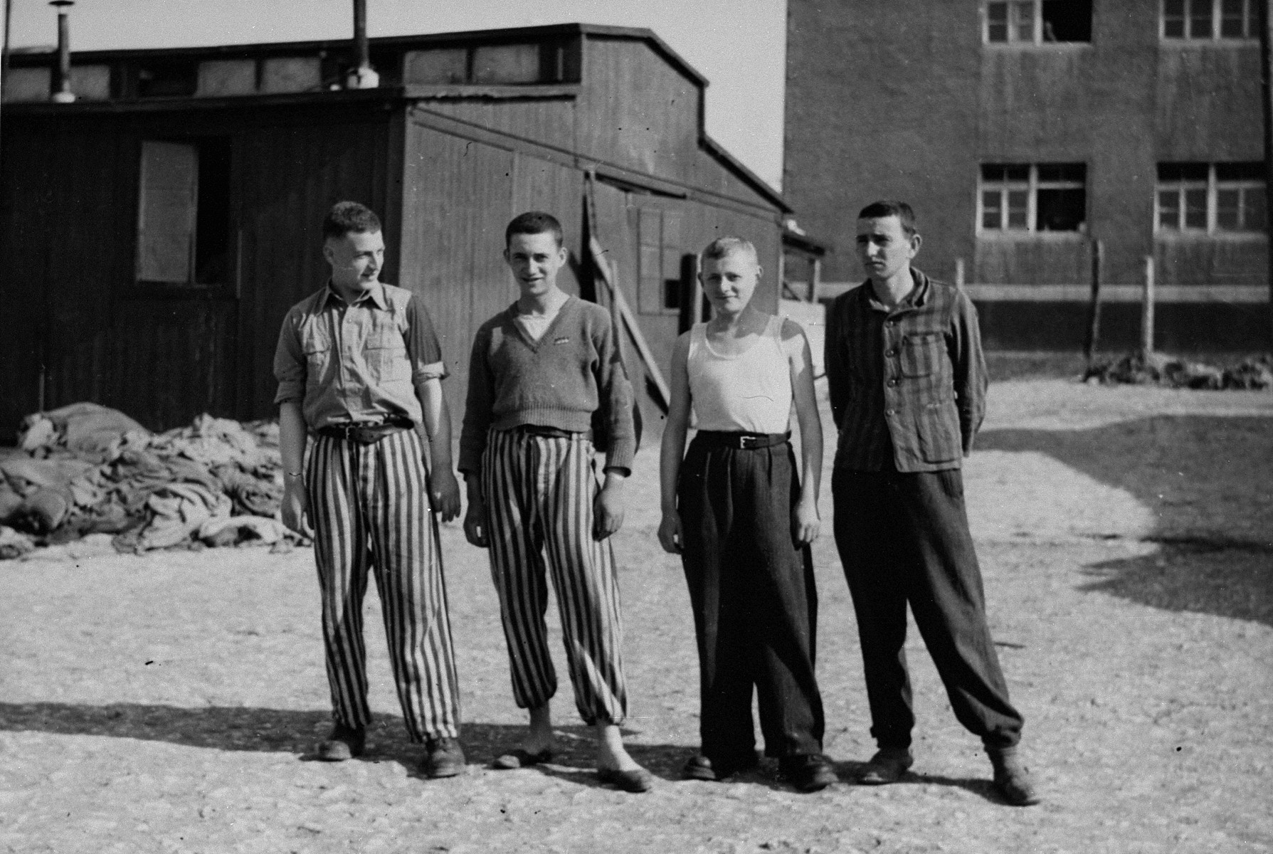 Portrait of four young survivors in Buchenwald concentration camp.