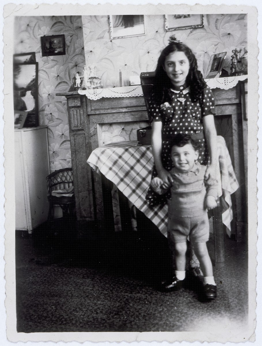 Two Jewish cousins pose in an apartment in Brussels where they are hiding as Christians.

Pictured are Flora Mendelowicz and Nathan (Nounou) Ciechanow.