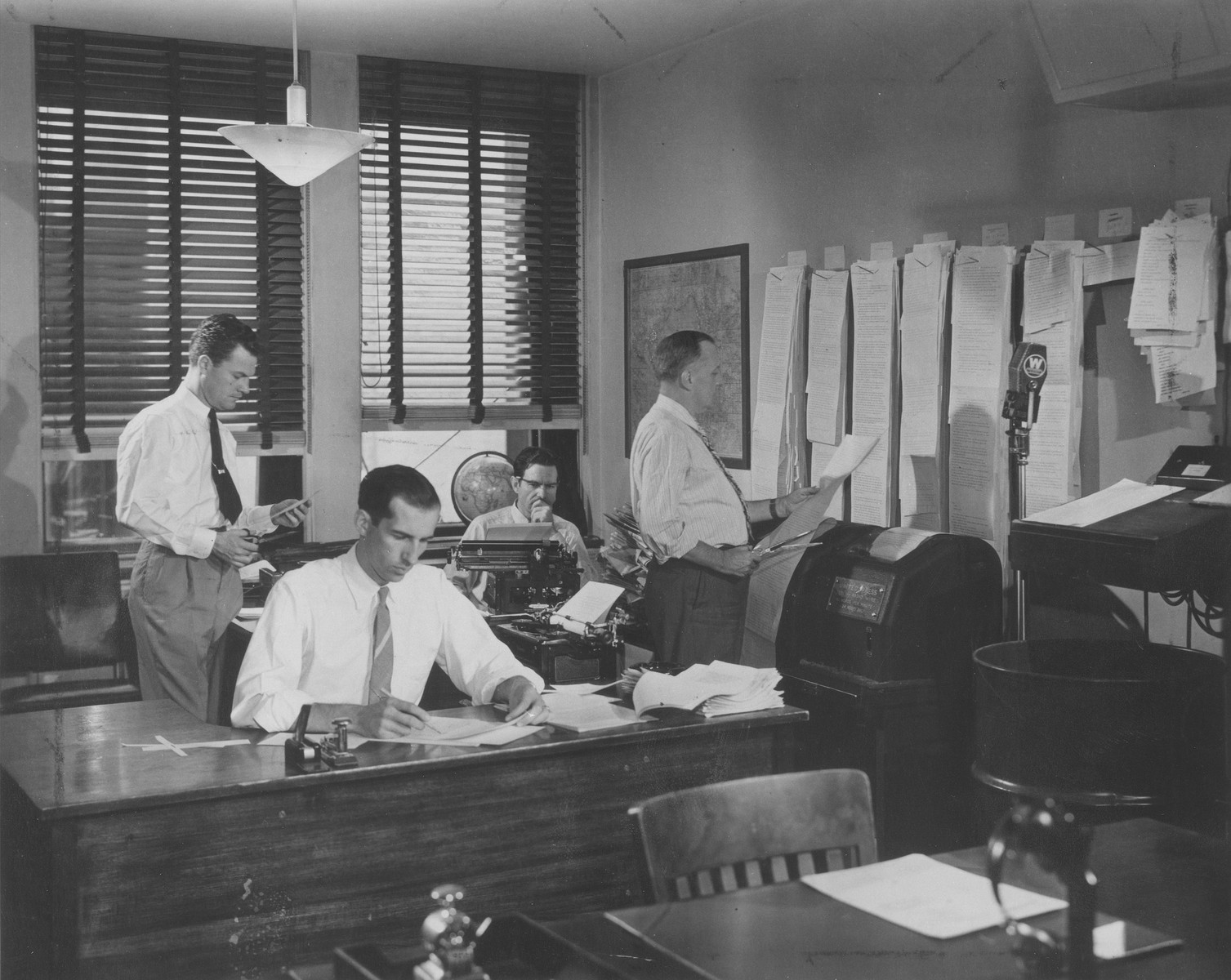 Teleprinter room in a large U. S. broadcasting station.  Here news from all parts of the world is received, sorted, edited, and prepared for broadcasting.