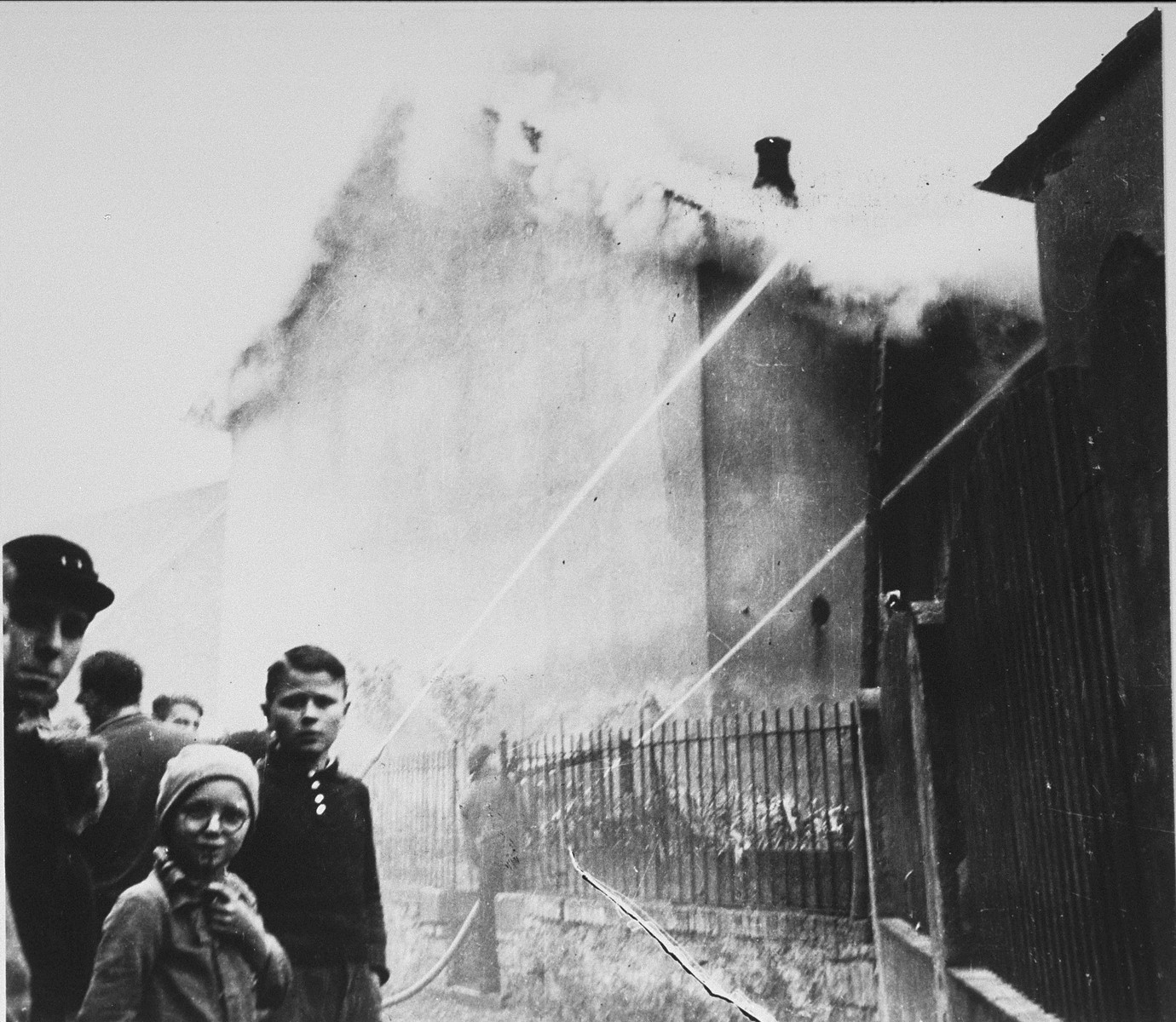 On the morning after Kristallnacht local residents watch as the Ober Ramstadt synagogue is destroyed by fire.   

The local fire department prevented the fire from spreading to a nearby home, but did not try to limit the damage to the synagogue.

The youth who took the series of photographs of the burning synagogue in Ober-Ramstadt, Georg Schmidt,  came from a family that opposed the Nazis.  The film was confiscated by police from Schmidt's home the same day the photos were taken, and developed immediately.  The prints and negatives were stored in the city hall until a policeman in the service of the American occupation found them and removed them.  The son-in-law of the policeman found them in a toolbox and donated them to the city archive.