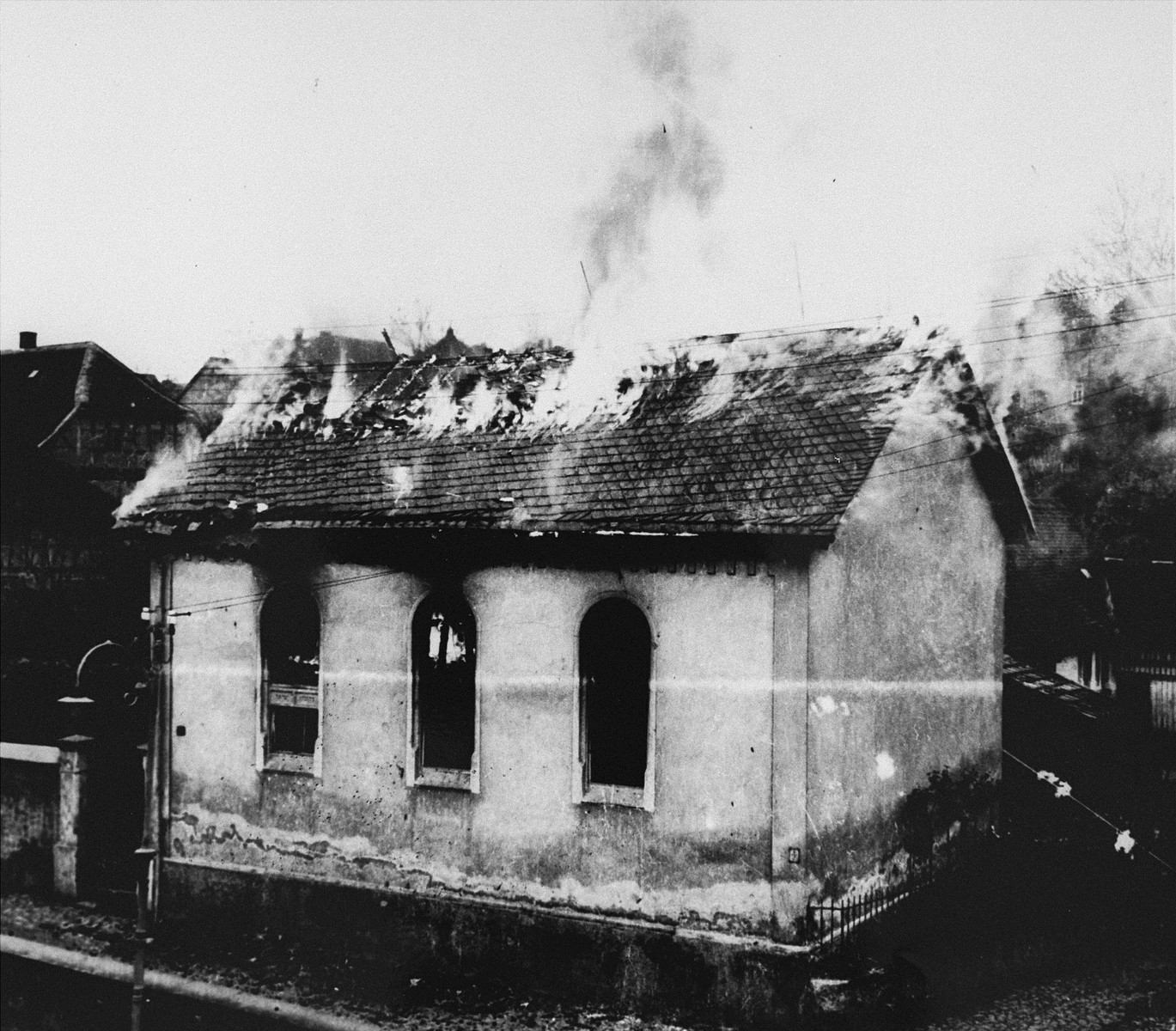 On the morning after Kristallnacht local residents watch as the Ober Ramstadt synagogue is destroyed by fire.   The local fire department prevented the fire from spreading to a nearby home, but did not try to limit the damage to the synagogue.

The youth who took the series of photographs of the burning synagogue in Ober-Ramstadt, Georg Schmidt,  came from a family that opposed the Nazis.  The film was confiscated by police from Schmidt's home the same day the photos were taken, and developed immediately.  The prints and negatives were stored in the city hall until a policeman in the service of the American occupation found them and removed them.  The son-in-law of the policeman found them in a toolbox and donated them to the city archive.