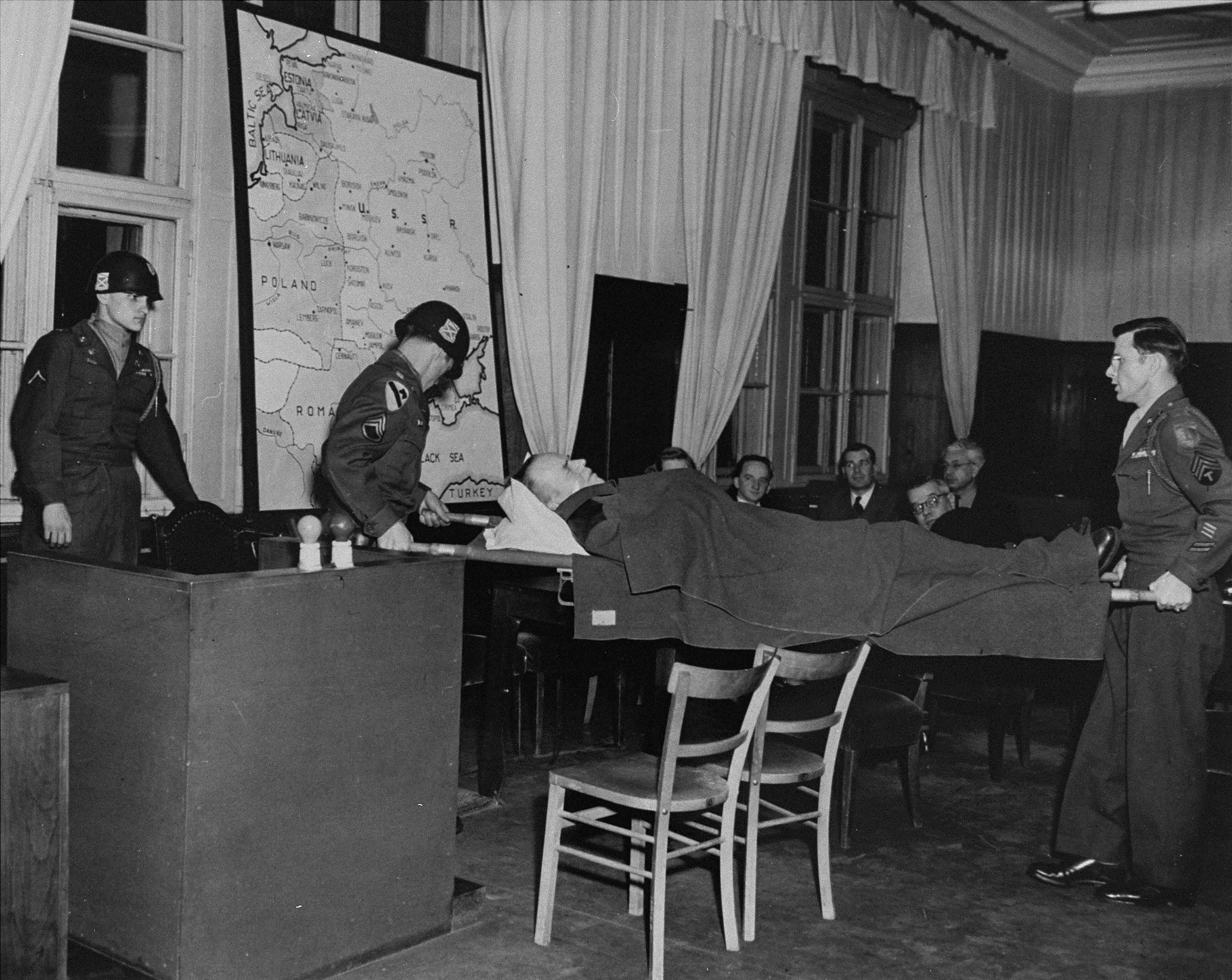 Defendant Otto Rasch gives testimony in a smaller courtroom in the Palace of Justice during the Einsatzgruppen Trial.  

Due to his mental and physical instability, the case against him was discontinued on 5 February 1948 and he subsequently died on 1 November 1948.