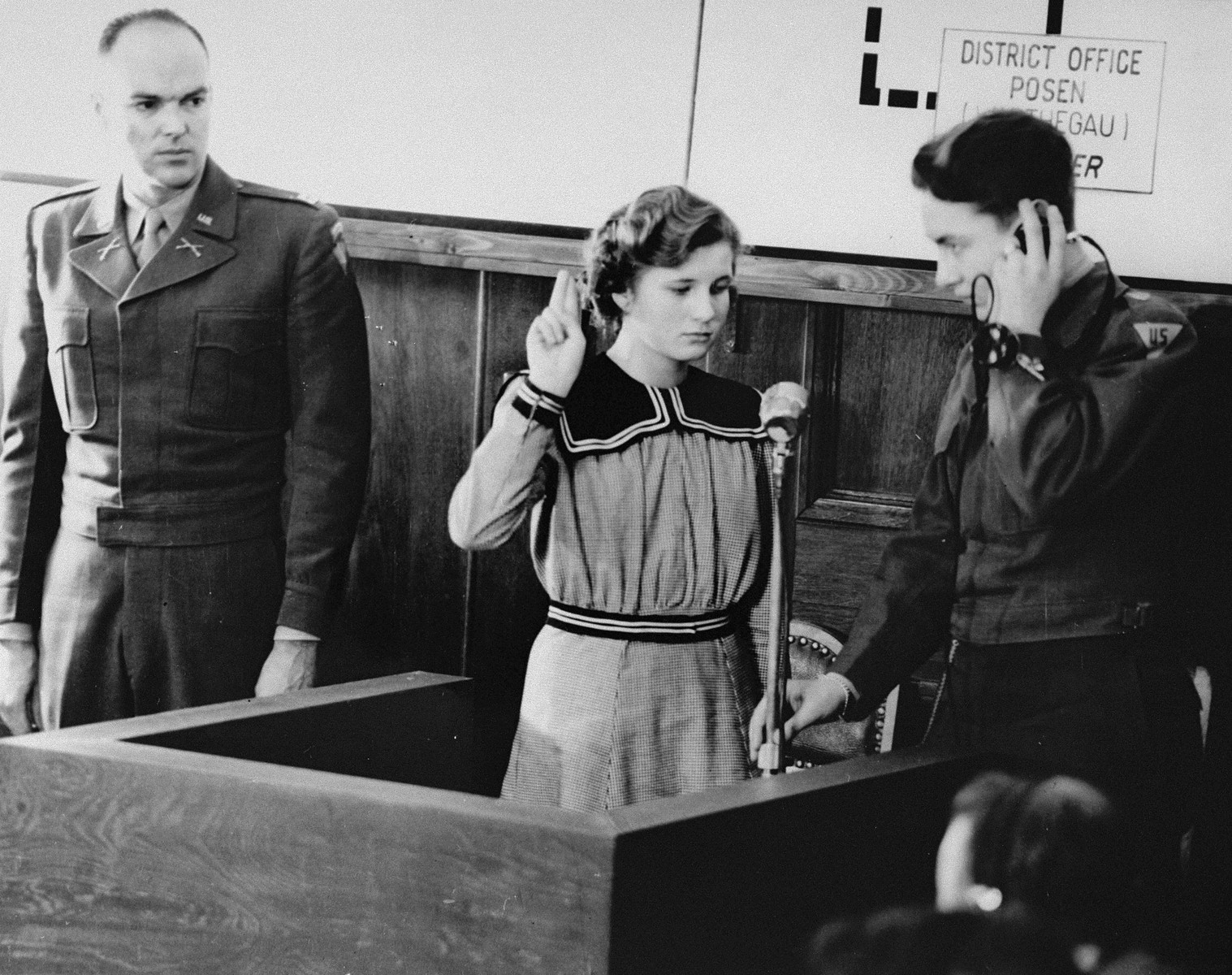 Fifteen-year-old Maria Dolezalova is sworn in as a prosecution witness at the RuSHA Trial.  Dolezalova was one of the children kidnapped by the Germans after they destroyed the town of Lidice, Czechoslovakia.