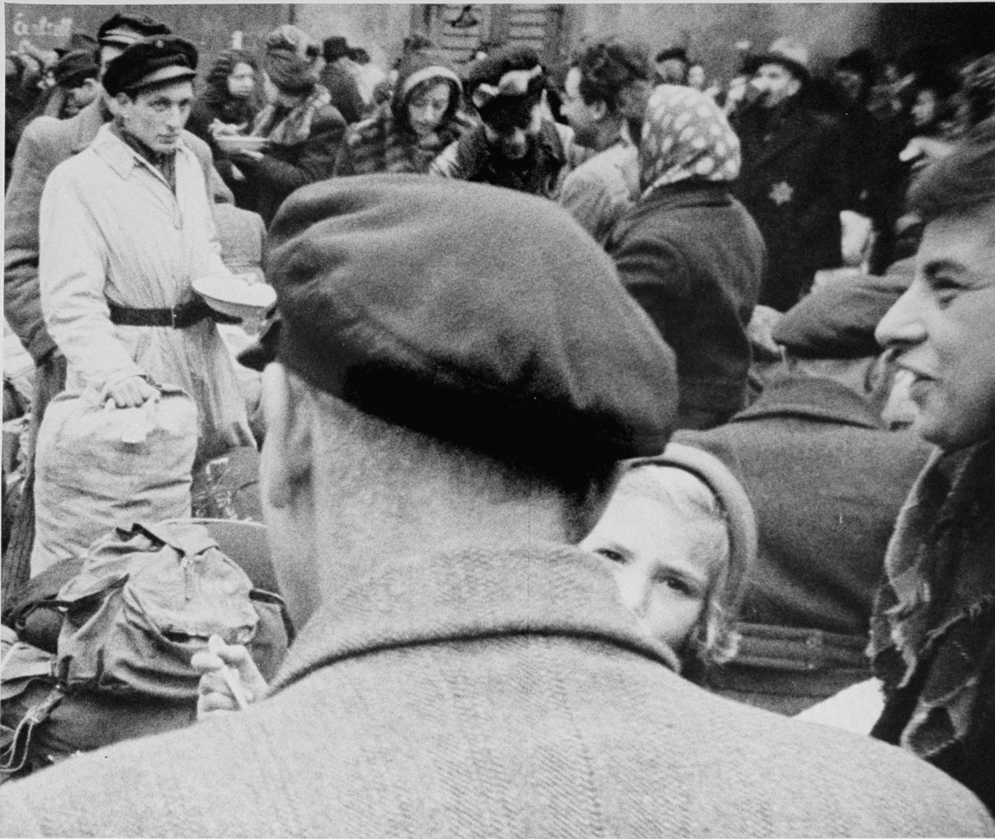 Members of a transport of Dutch Jews that has just arrived in Theresienstadt are gathered in the courtyard of the ghetto. [oversized photo]