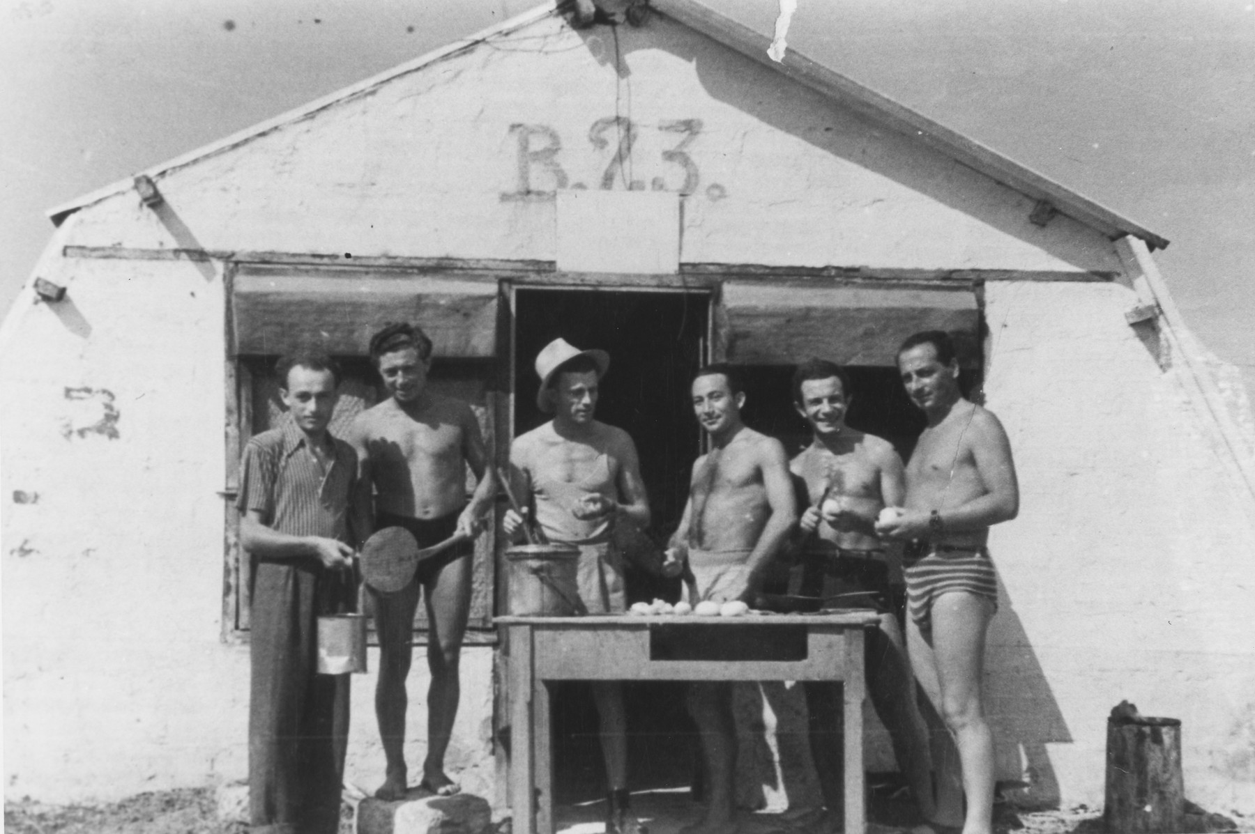 Jewish DPs peel potatoes outside barracks 23 in Santa Maria di Leuca.

Pinkus Gipsman is pictured second from the left.