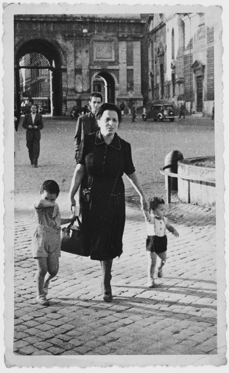 Lina Tagliacozzo walks down a street in Rome with her two young children David and Nando.