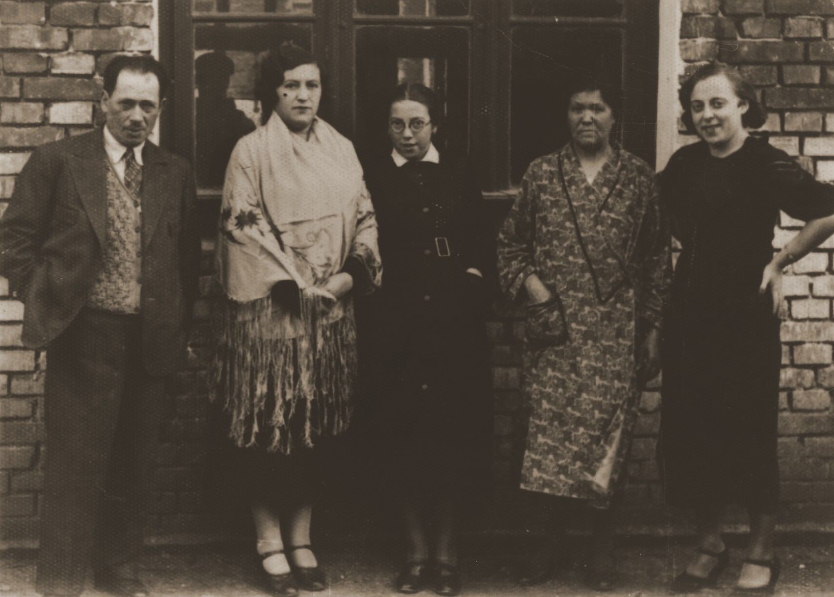 Members of the extended Berland family pose in back of their new home in Chelm.  Pictured from left to right are:  Abraham, Sara and Felicja Berland; Chaya Rachel Hilf (Sara's mother); and Hela Zonenszajn (Sara's cousin).