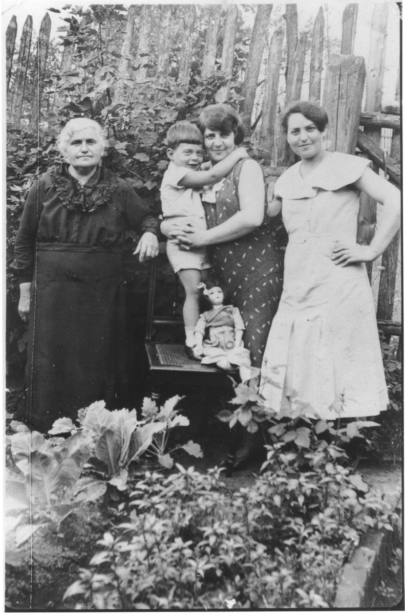 A Jewish family poses outside in their garden. 

Ruth (Kaufmann) Kaiser (right) poses with her mother, sister and nephew.  Pictured from left to right are: Jetchen Kaufmann, Henry Lorsch, Selma (Kaufmann) Lorsch and Ruth (Kaufmann) Kaiser.