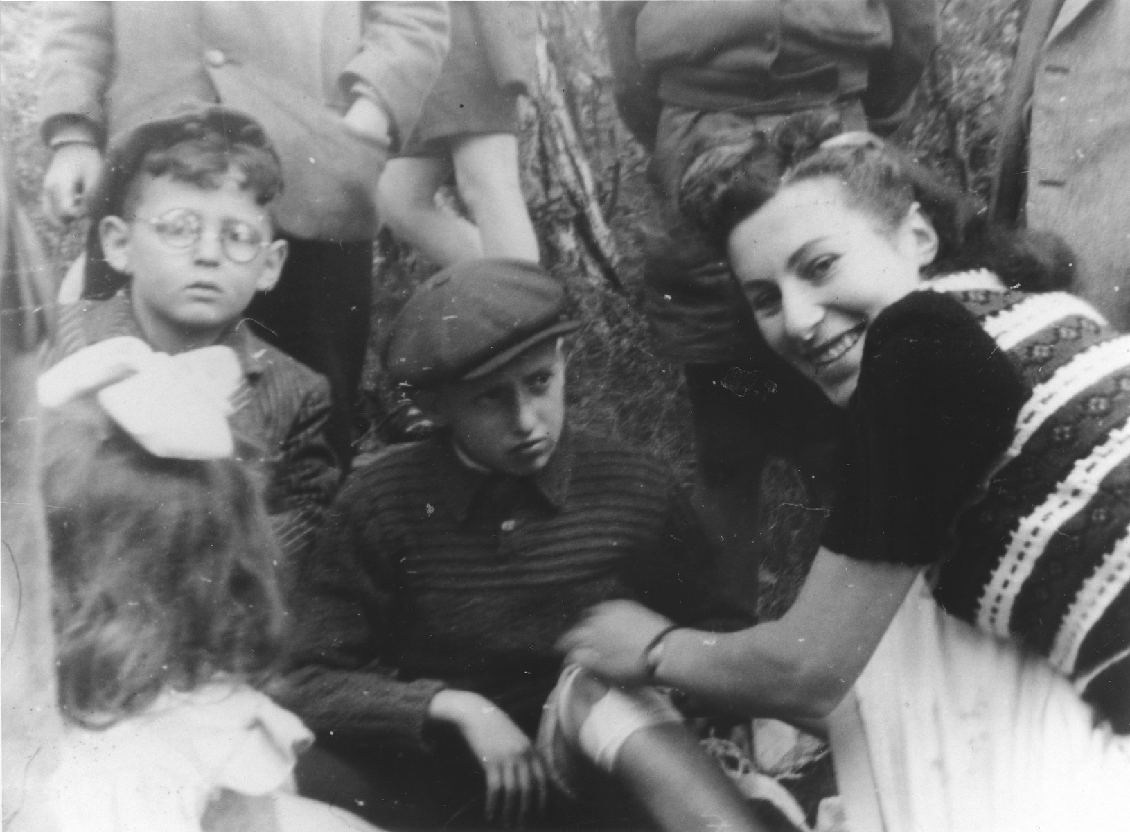 A Red Cross worker bandages a child's leg in the Ulm displaced persons camp.

Srulek Rajs is pictured on the far left.