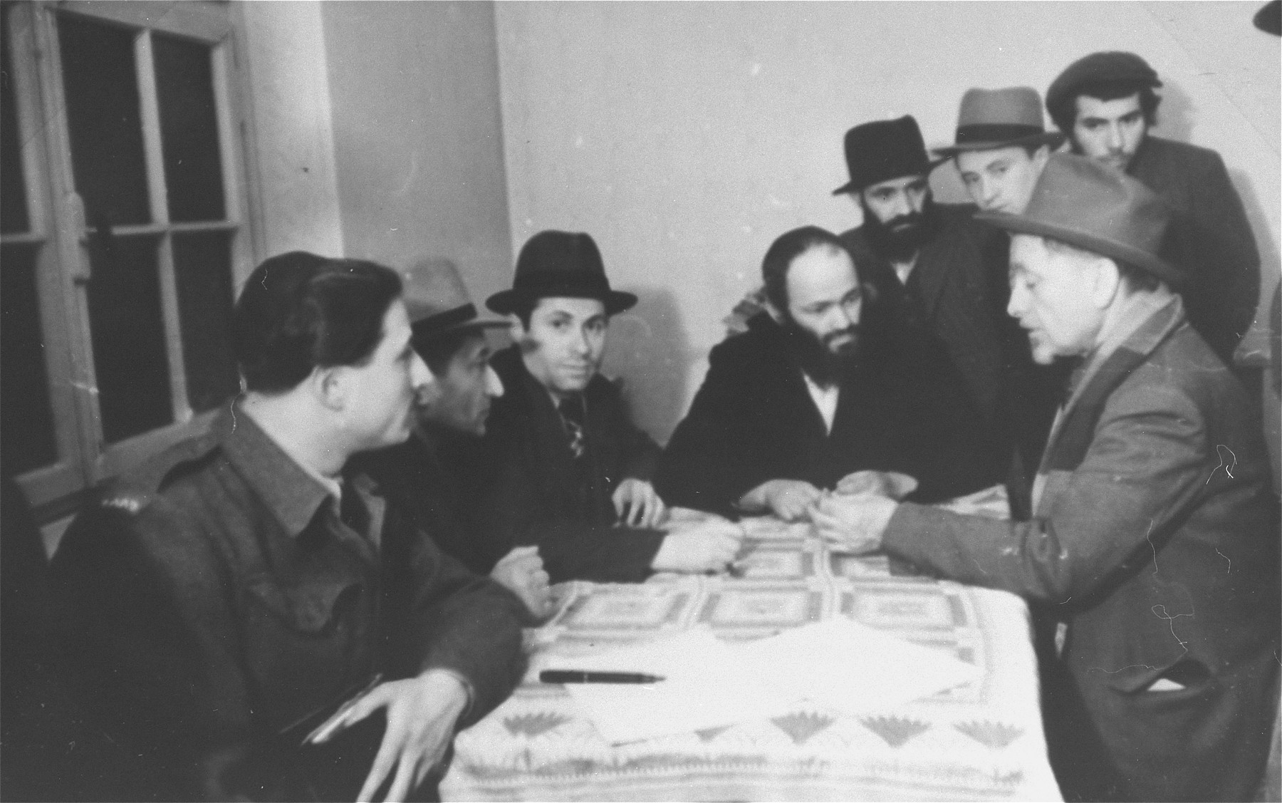 Yeshiva students gather together around a table in the Zeilsheim displaced persons' camp.