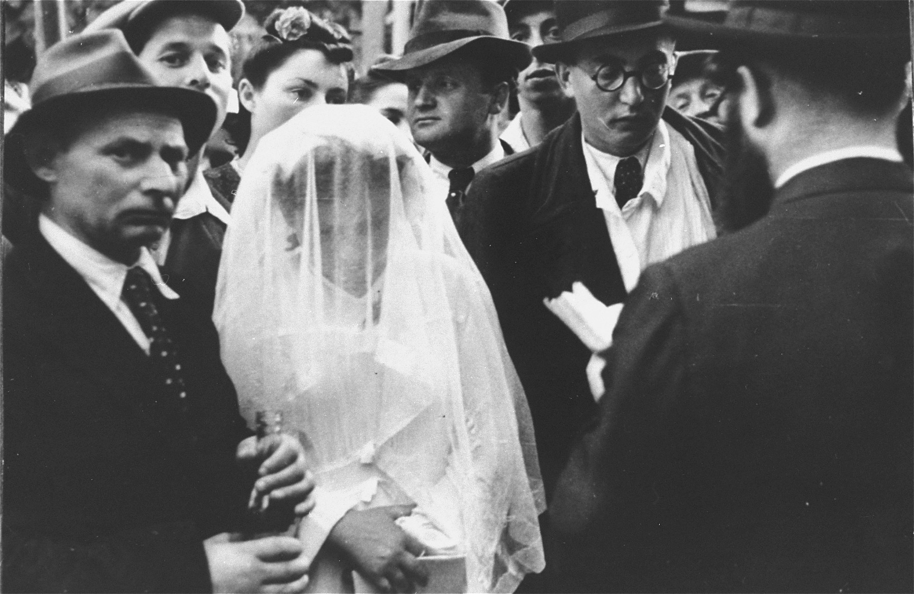 Wedding ceremony at the Zeilsheim displaced persons' camp.  The rabbi recites the marriage blessings under the huppah (canopy).
