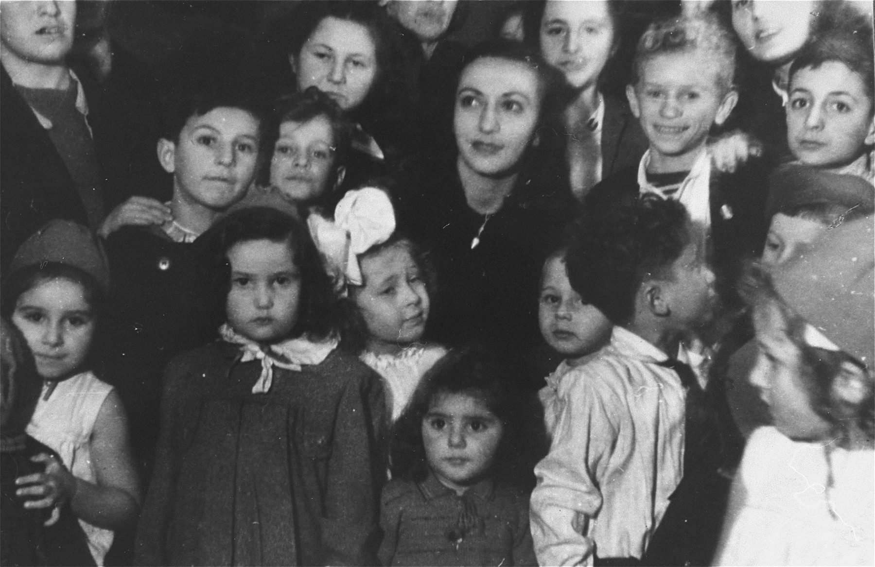 Children crowd together for a Hanukkah celebration in the Zeilsheim displaced persons' camp.

Those pictured include Szlomo Waks (second from right, second row from top), Bluma Berk (bottom left), and Shalom Lewin (front row, second from right).