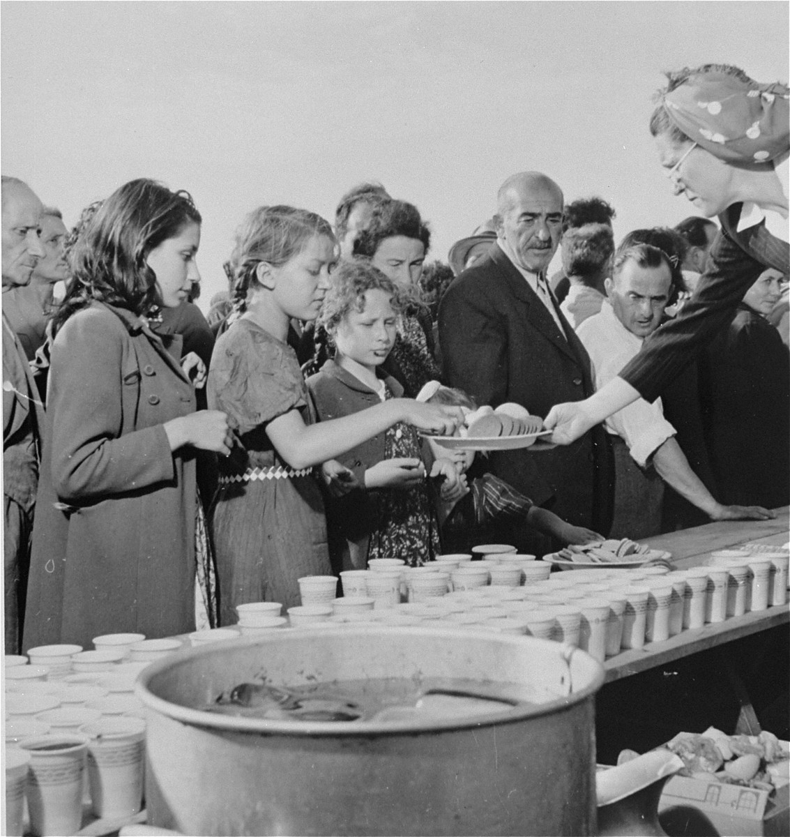 Newly arrived refugees receive food and drink at a picnic at Fort Ontario in Oswego, New York.