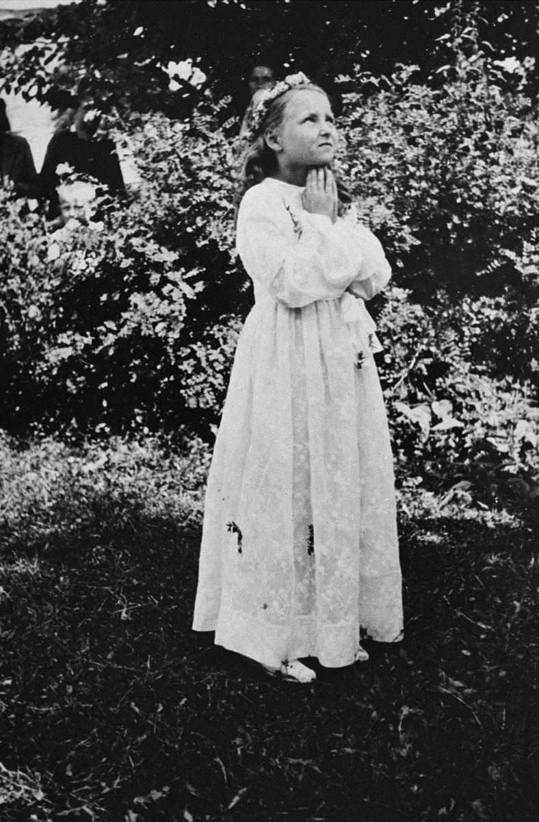 Portrait of a Jewish child dressed for her First Communion.

Pictured is Selma Schwarzwald, who had lived in hiding as a Polish Catholic during the war.