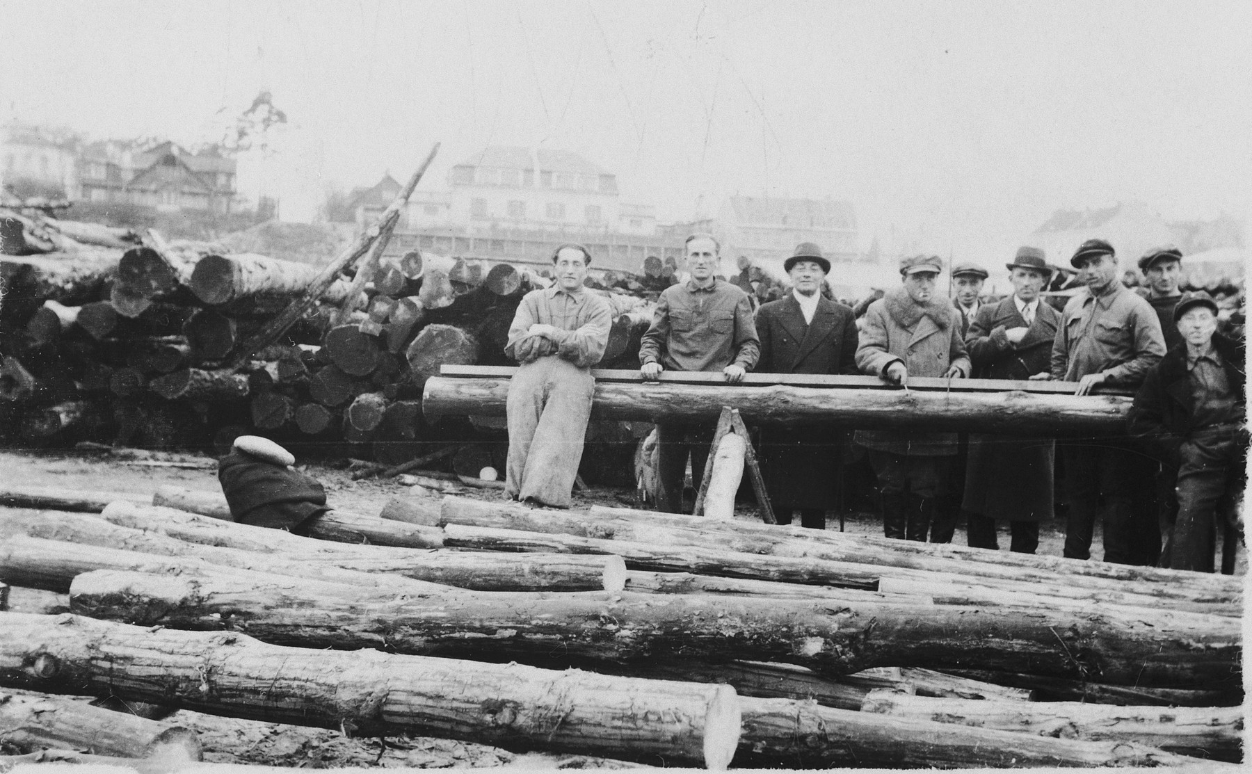 David Shapiro poses in his lumberyard with young Lithuanian Jews who were learning the trade to prepare for their immigration to Palestine.
