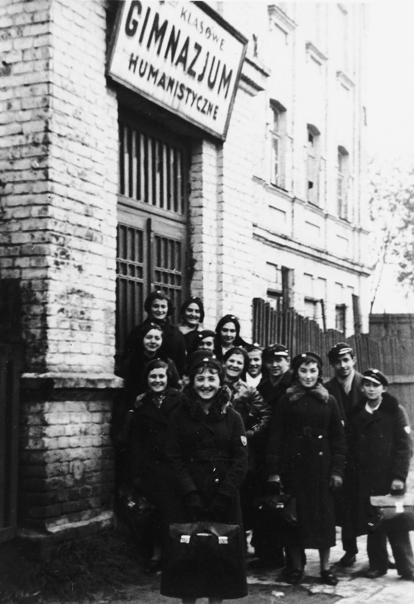 Students wearing school uniforms pose outside the Epstein Polish Gymnasium.

Among those pictured (back row, far left)  is Adele Grynholtz (now Adele Jochelson), who attended Epstein Gymnasium until 1938.