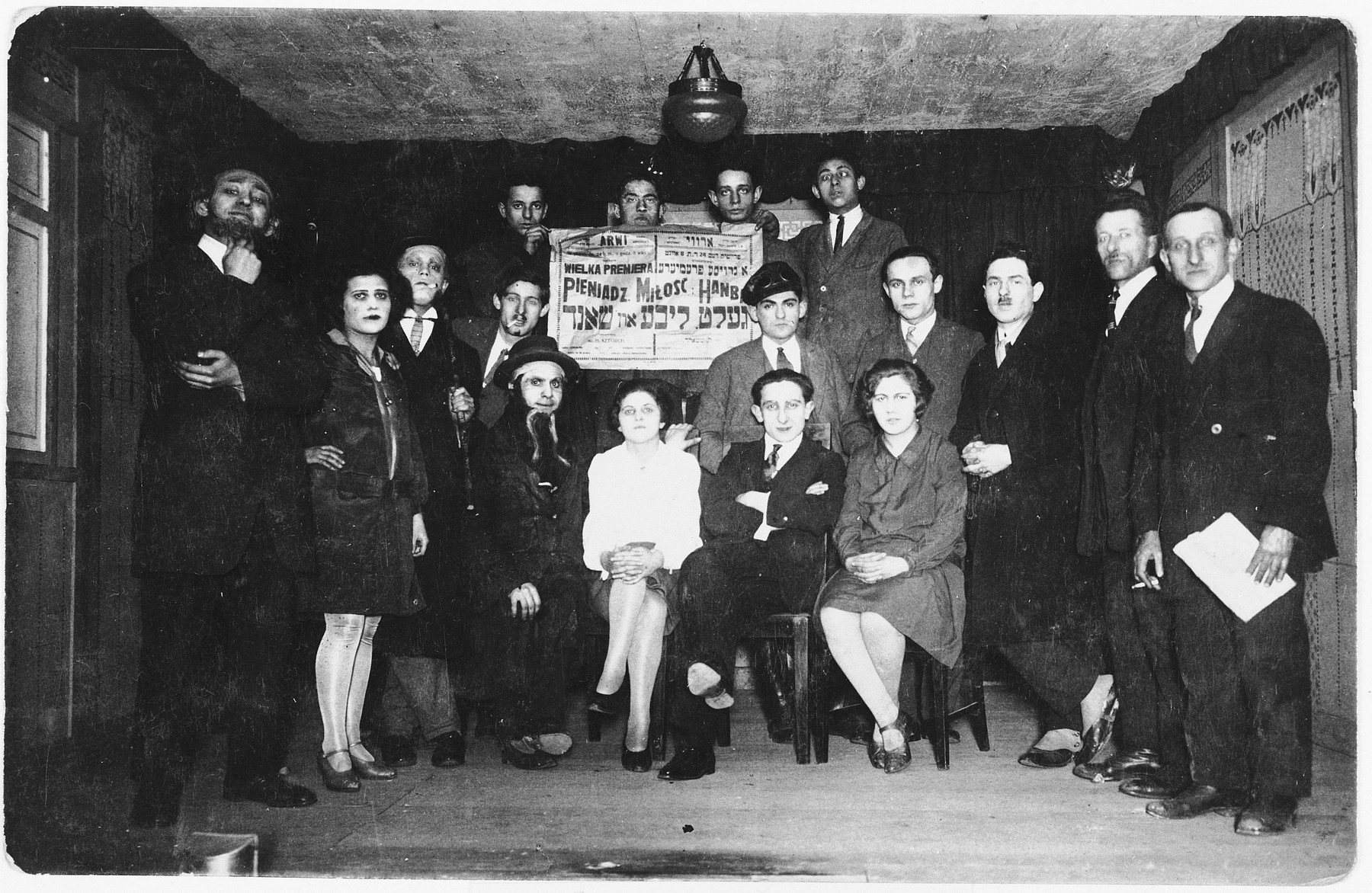 Members of the Bundist theater group "Arvi" perform the "Money, Love and Shame".

Heniek Storch (seated first row, second from right) directed the production.  Also pictured is Szmerling (extreme right).
