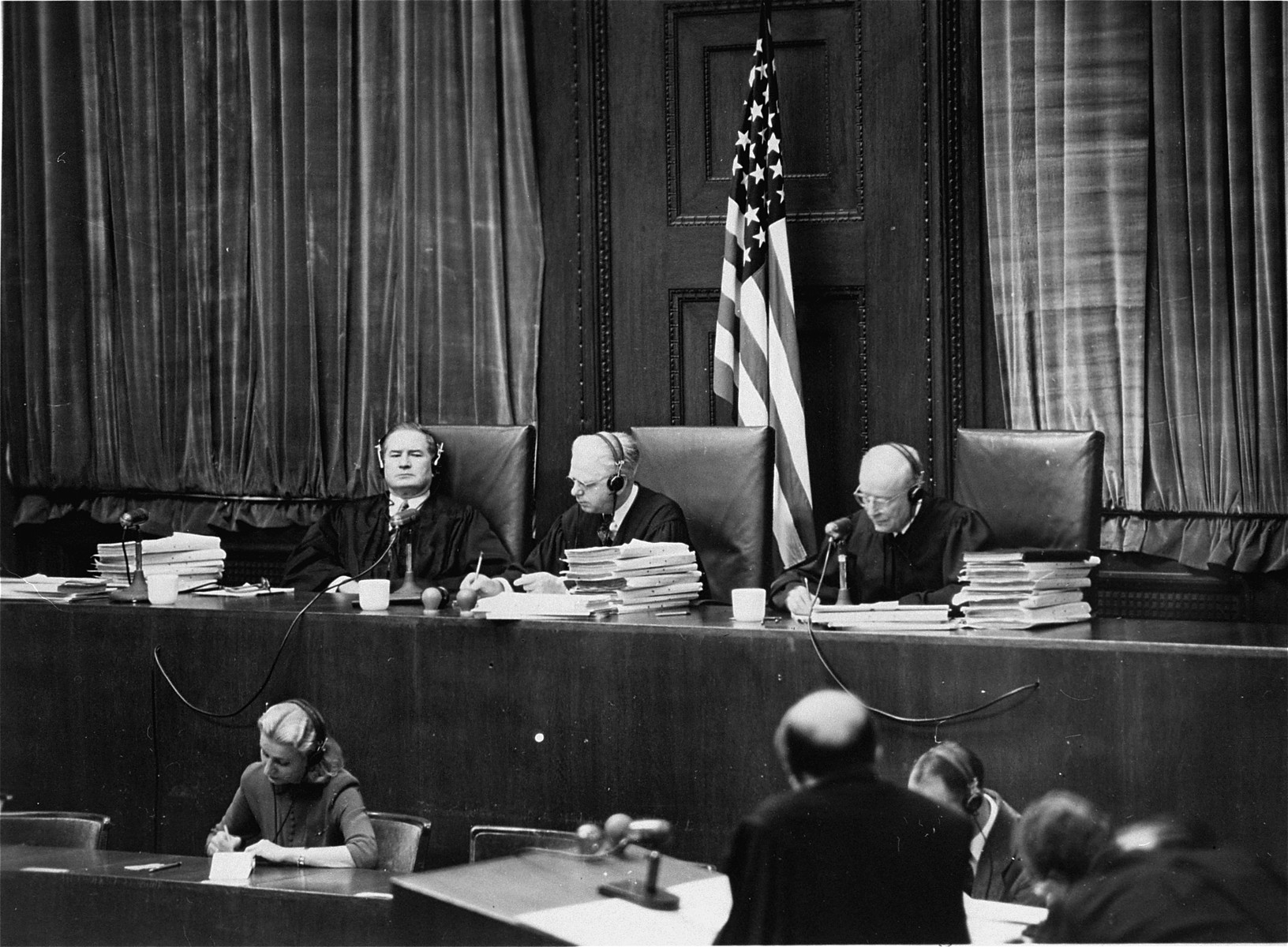 The members of the Tribunal at the Ministries Trial.  Seated from left to right are Leon W. Powers, Presiding Justice William C. Christianson, and Robert T. Maguire.