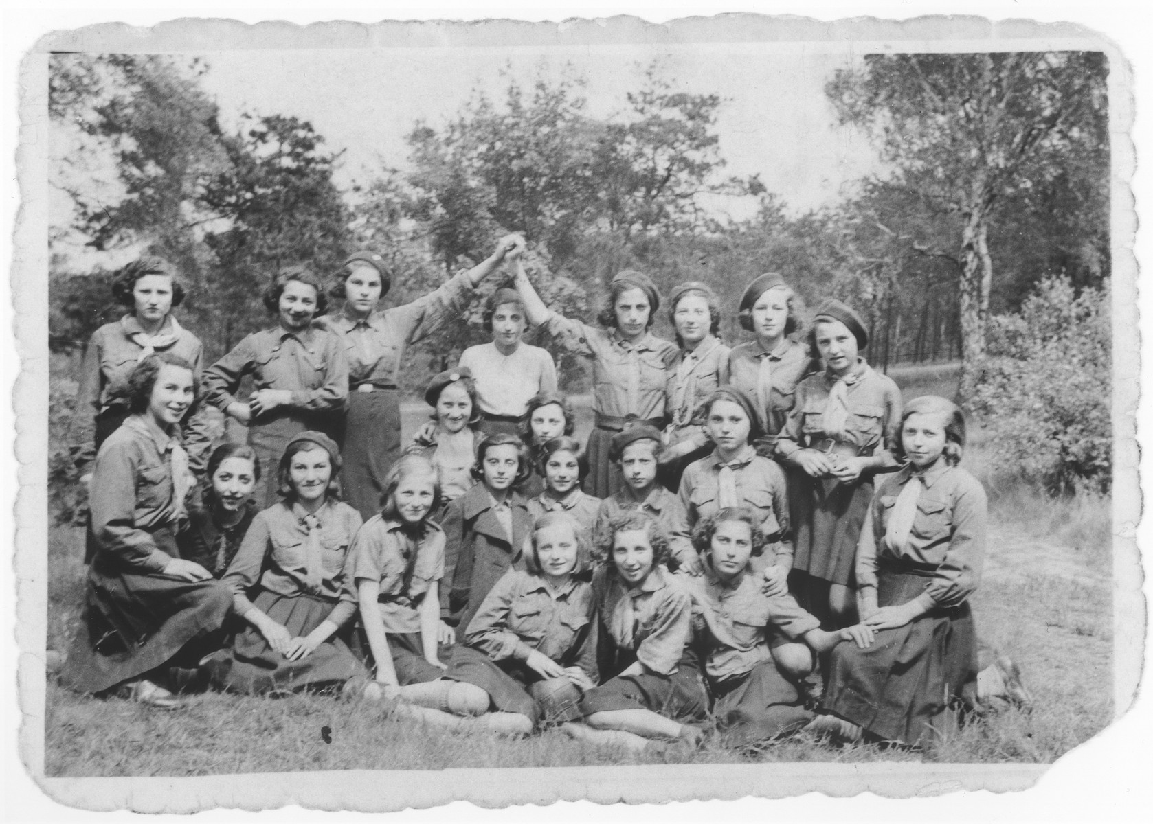 Group portrait of members of a Jewish girl scouting movement on an outing.

Among those pictured are Hela Szpiro, Estusia Fromer, Genia Dunska, Hadassa Cudzynowski, Rozia Feller, and Marisza Stibelman.