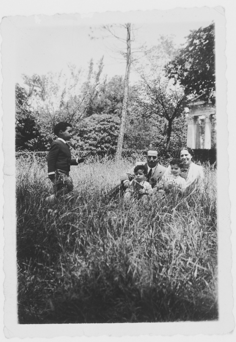 The Tagliacozzo family relaxes in a garden.

Seated are Giovanni Dell'Ariccia and Adele Tagliacozzo Dell'Ariccia and their sons David and Leilo.  On the left is their nephew David Tagliacozzo.