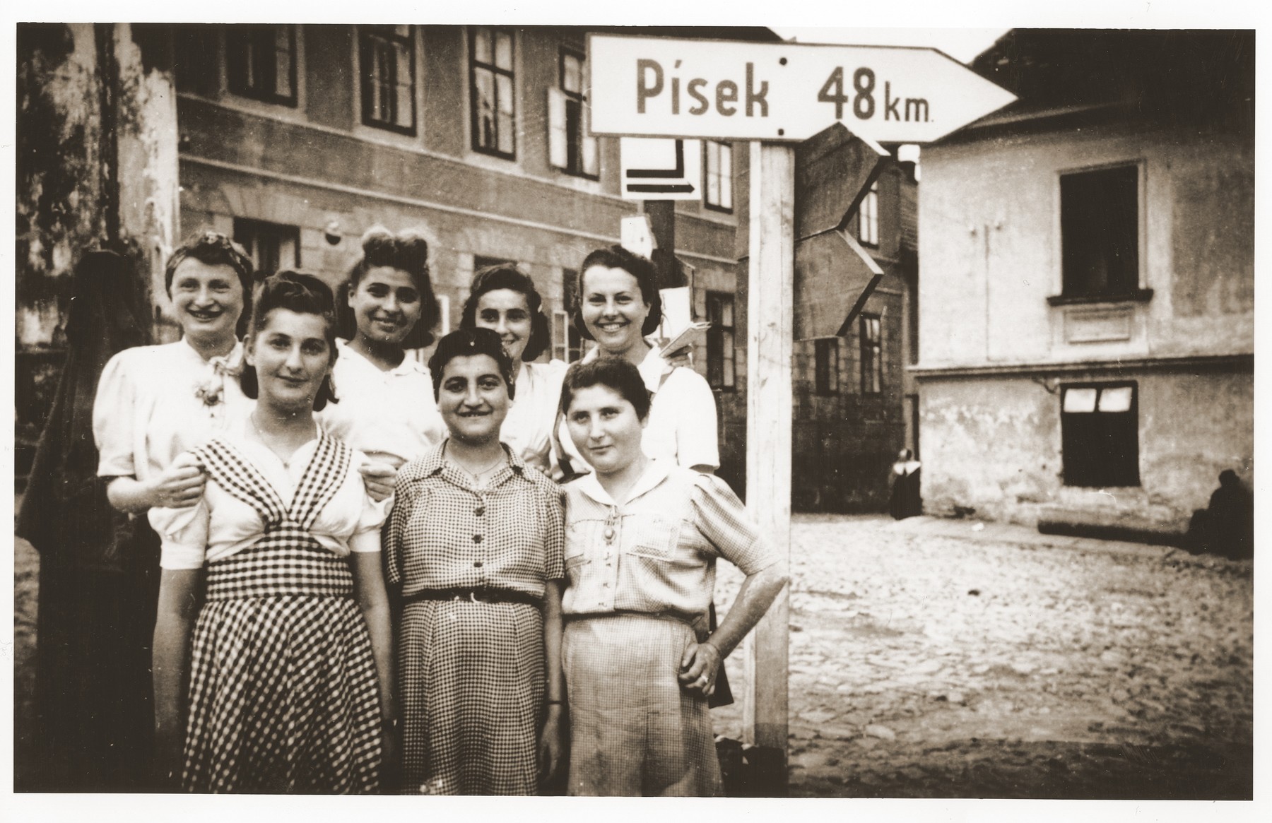 Seven of the approximately 150 survivors of a 500 km. death march that ended in Volary.  These Jewish survivors are recuperating in Prachatice, near Volary. 

Pictured from left to right in the front row are: Hela Malinowicz (Malnowicer Bleeman) (from Dabrowa); Rachela Raabe; and Regina Szapelska (from Sosnowiec).   In the back row, left to right are: Hela Dancygier; Lilka Silbiger (from Oswiecim); Fela Lewy; and Fela Zyngler (from Lodz).