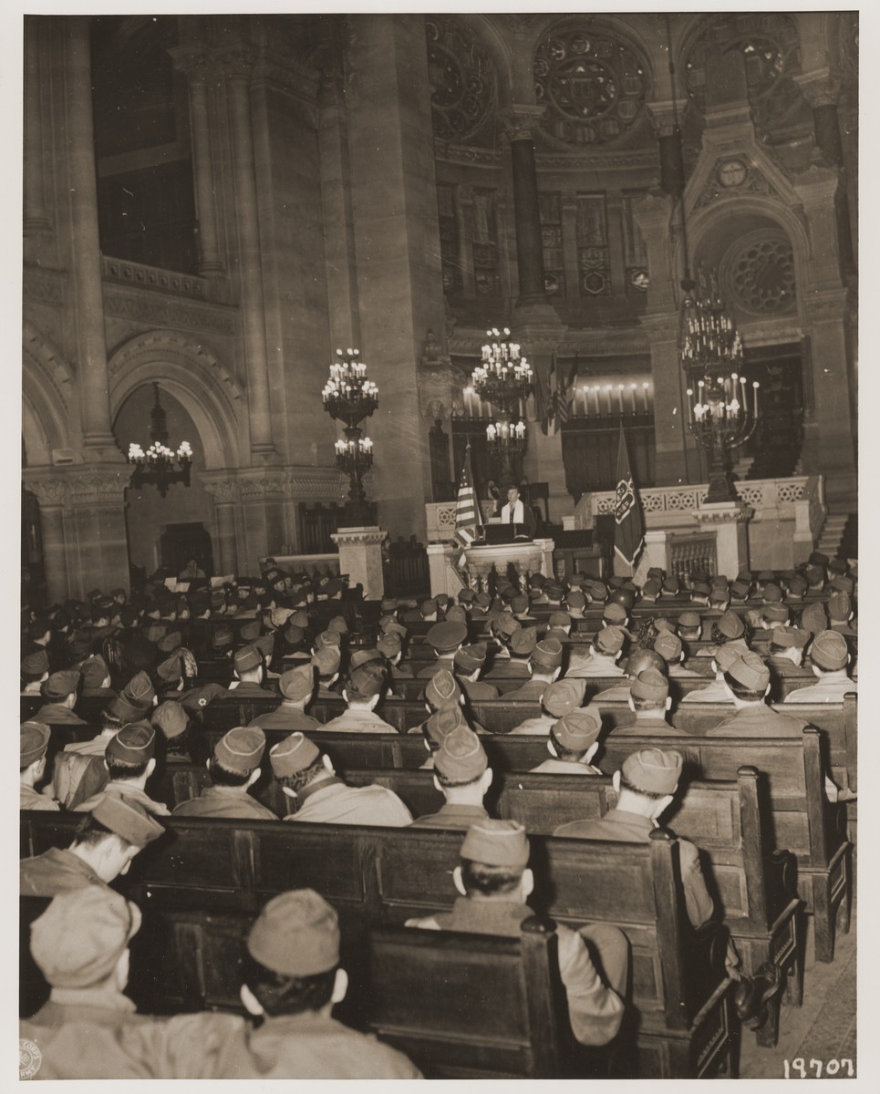 Chaplain Judah Nadich delivers a sermon to American servicemen at a Thanksgiving service in the rue de la Victoire synagogue in Paris.