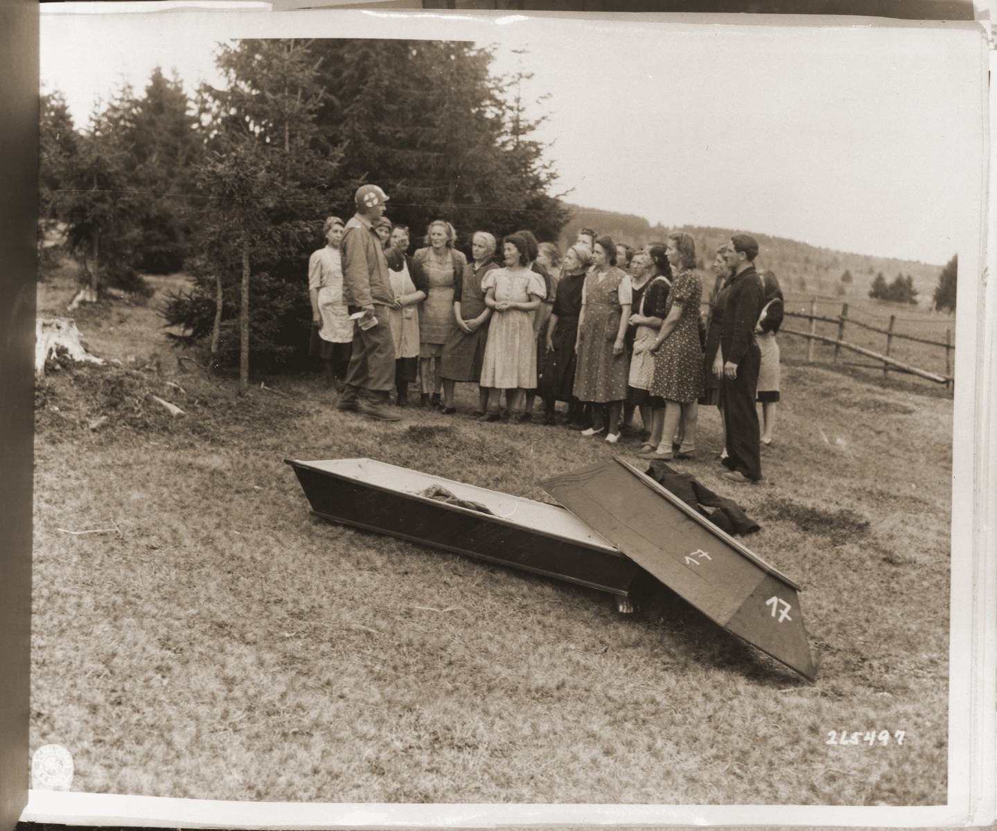German civilians look at the bodies of Jewish women exhumed from a mass grave in Volary.  The victims died at the end of a death march from Helmbrechts, a sub-camp of Flossenbuerg.