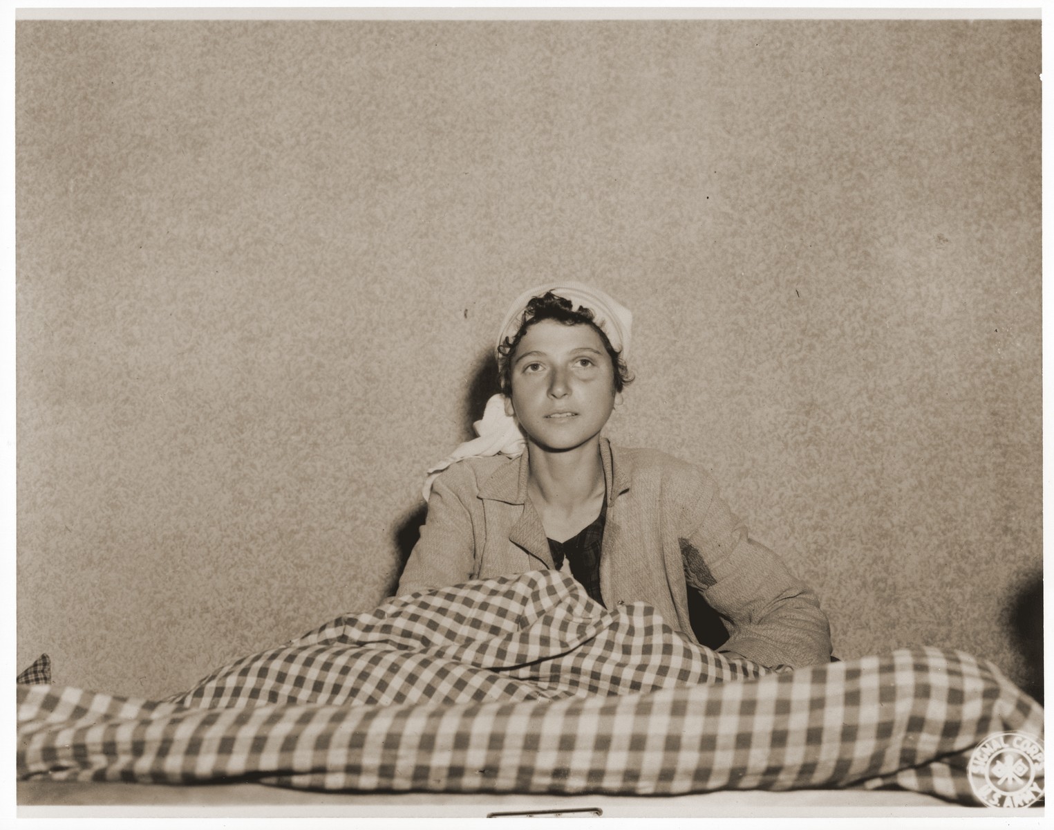 An emaciated female Jewish survivor of a death march sits up in bed at an American military field hospital in Volary, Czechoslovakia.

Pictured is twenty-two year old Gizal Warum.
