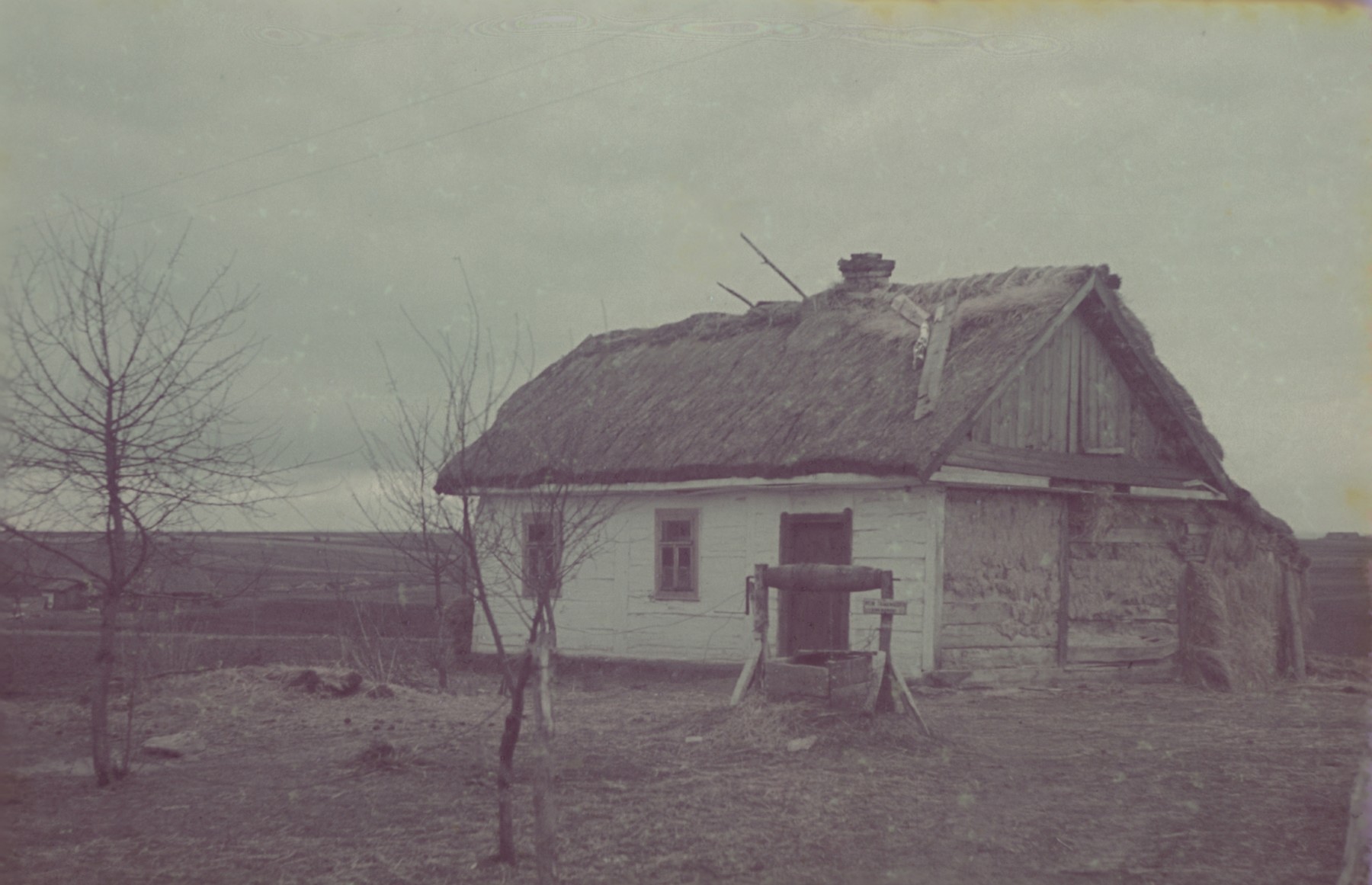 A view of a house with a thatched roof in or near Lodz.