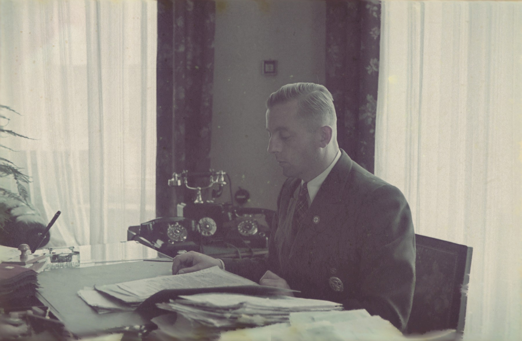 Hans Biebow, German head of the Lodz ghetto administration, at his desk.
